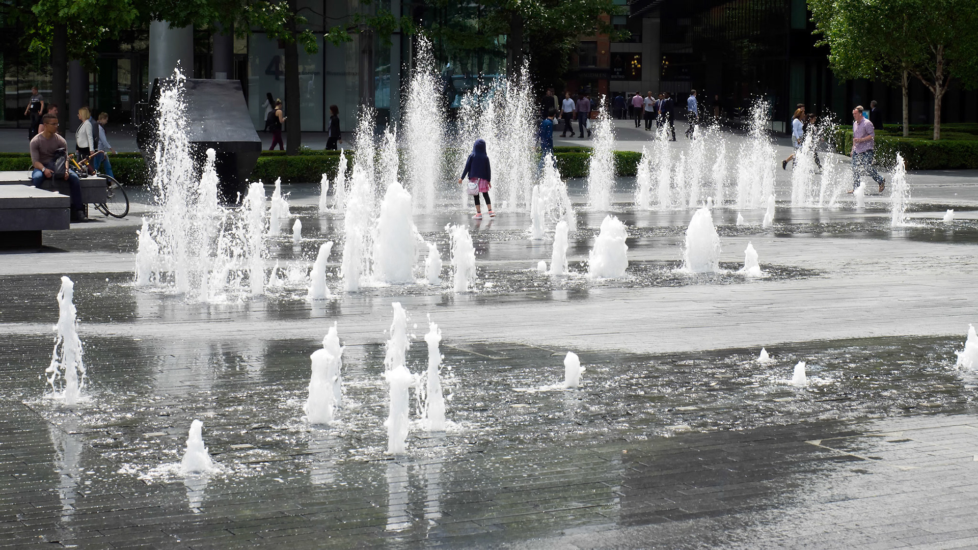 Person Standing in the Middle of a Fountain in London