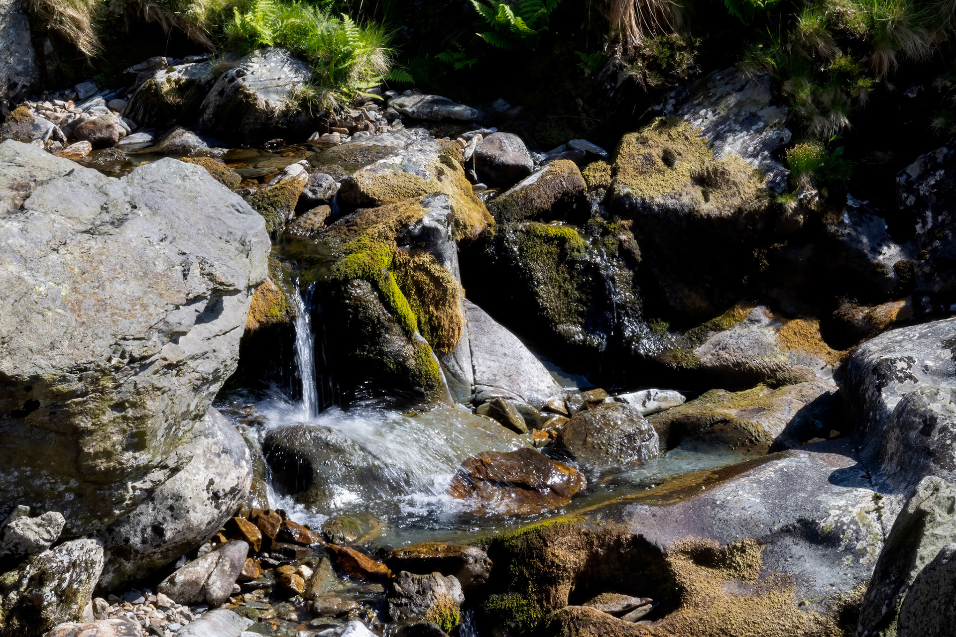 Water trickling over rocks in a Welsh river in springtime