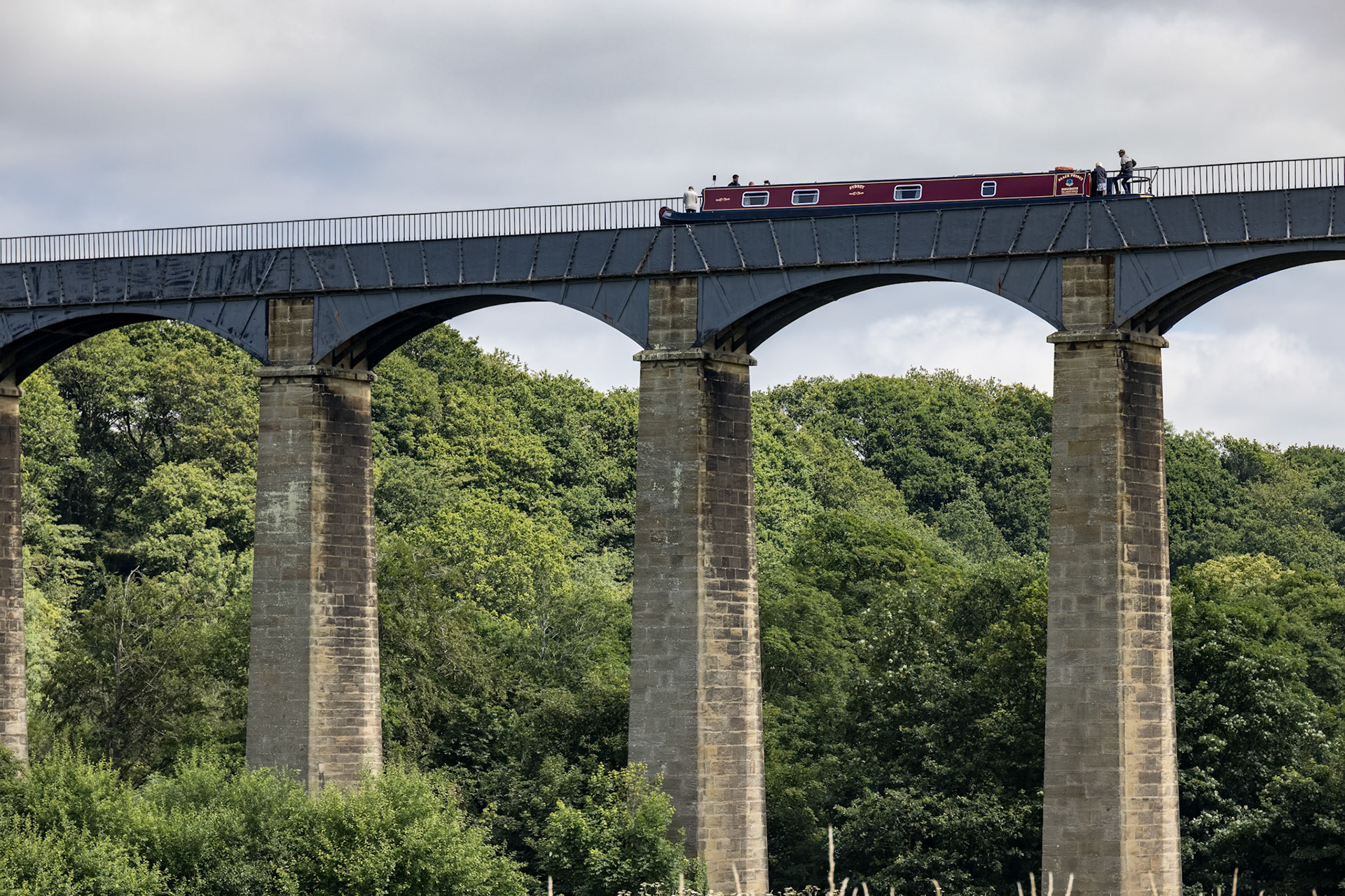 FRONCYSYLLTE, WREXHAM, WALES - JULY 15 : Narrow boat on the Pontcysyllte Aqueduct near Froncysyllte, Wrexham, Wales, UK on July 15, 2021. Unidentified