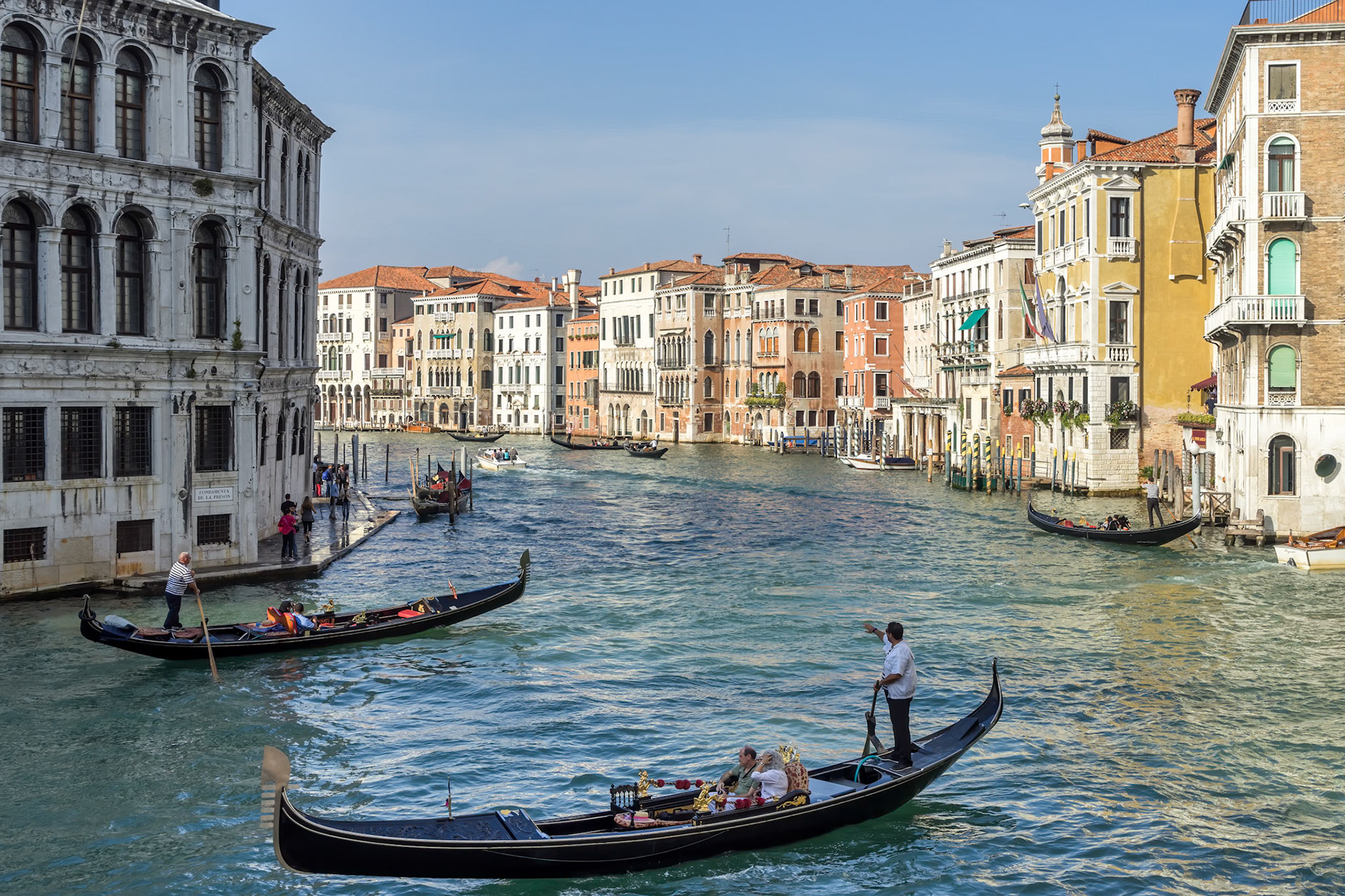 VENICE, ITALY - OCTOBER 12 : Gondoliers plying their trade on the Grand Canal Venice on October 12, 2014. Unidentified people