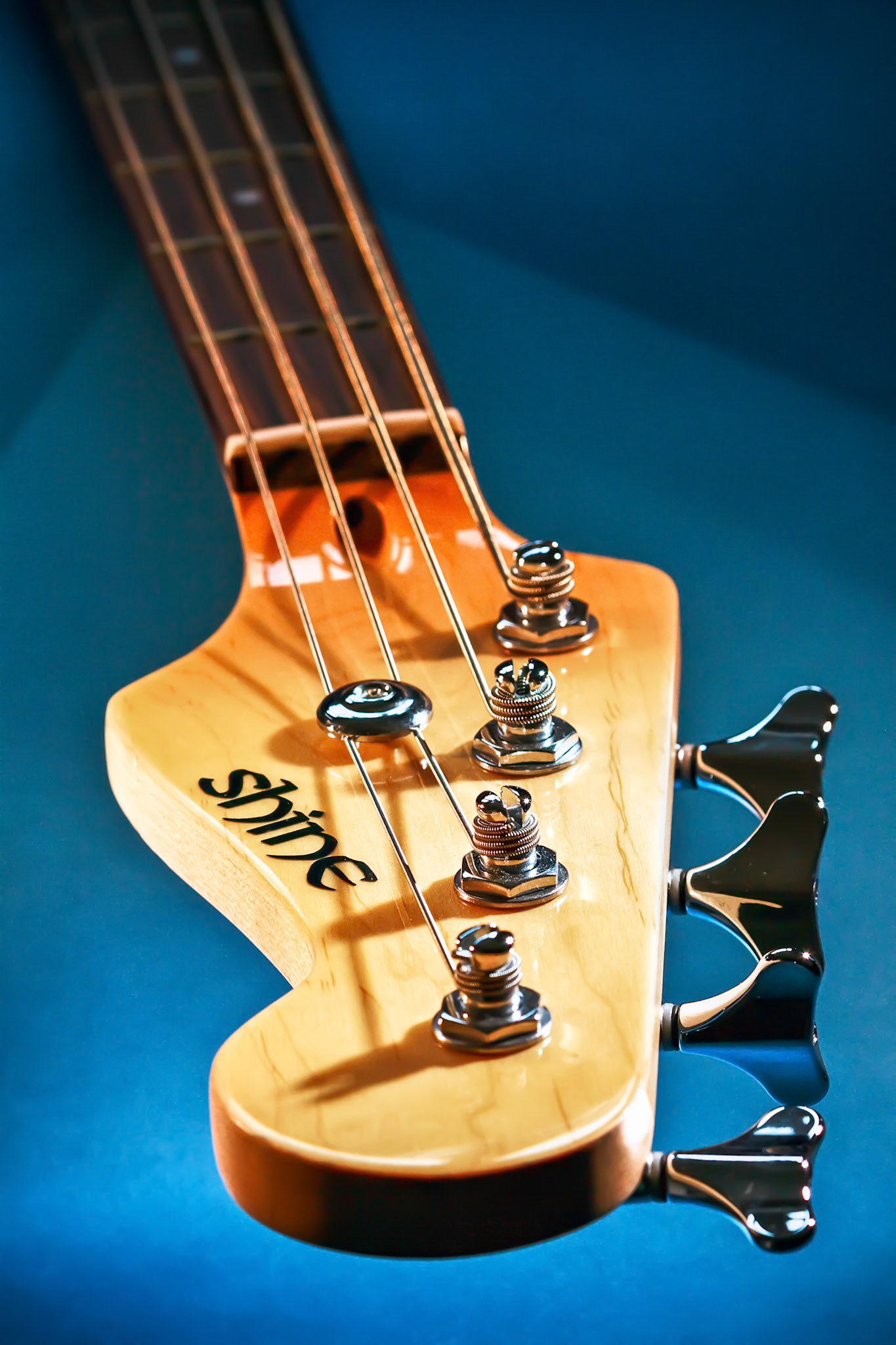 Close-up Electric Bass Guitar Head and Tuning Pegs