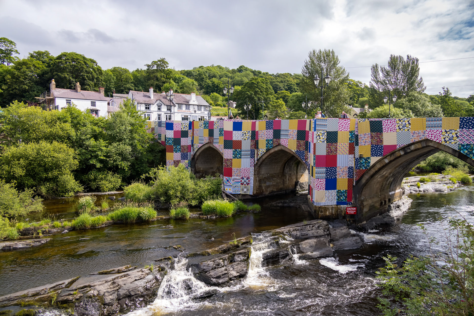 LLANGOLLEN, DENBIGHSHIRE, WALES - JULY 11 : View along the River Dee in LLangollen, Wales on July 11, 2021. Unidentified people