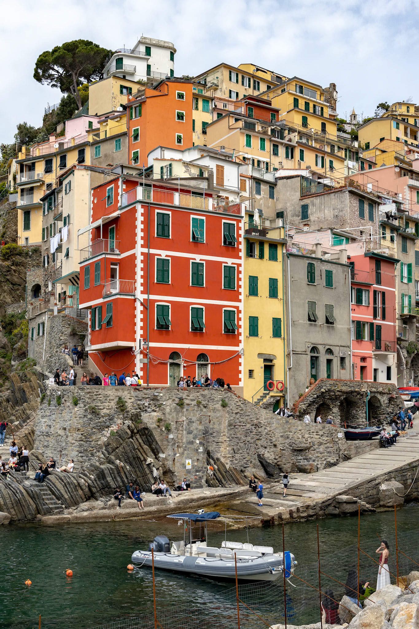 RIOMAGGIORE, LIGURIA/ITALY  - APRIL 21 : Coastline view of Riomaggiore Liguria Italy on April 21, 2019. Unidentified people