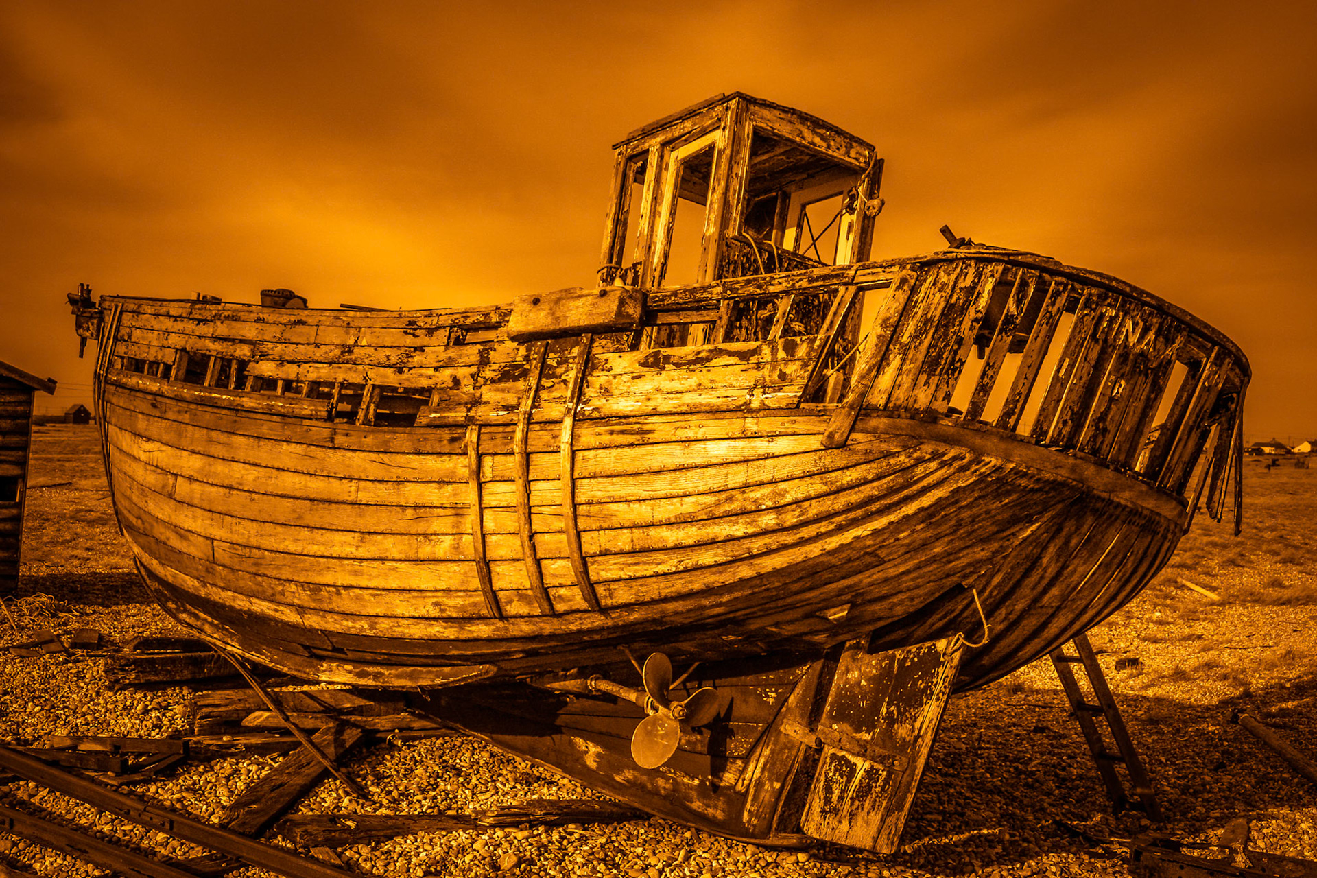 Derelict boat on Dungeness beach in Kent