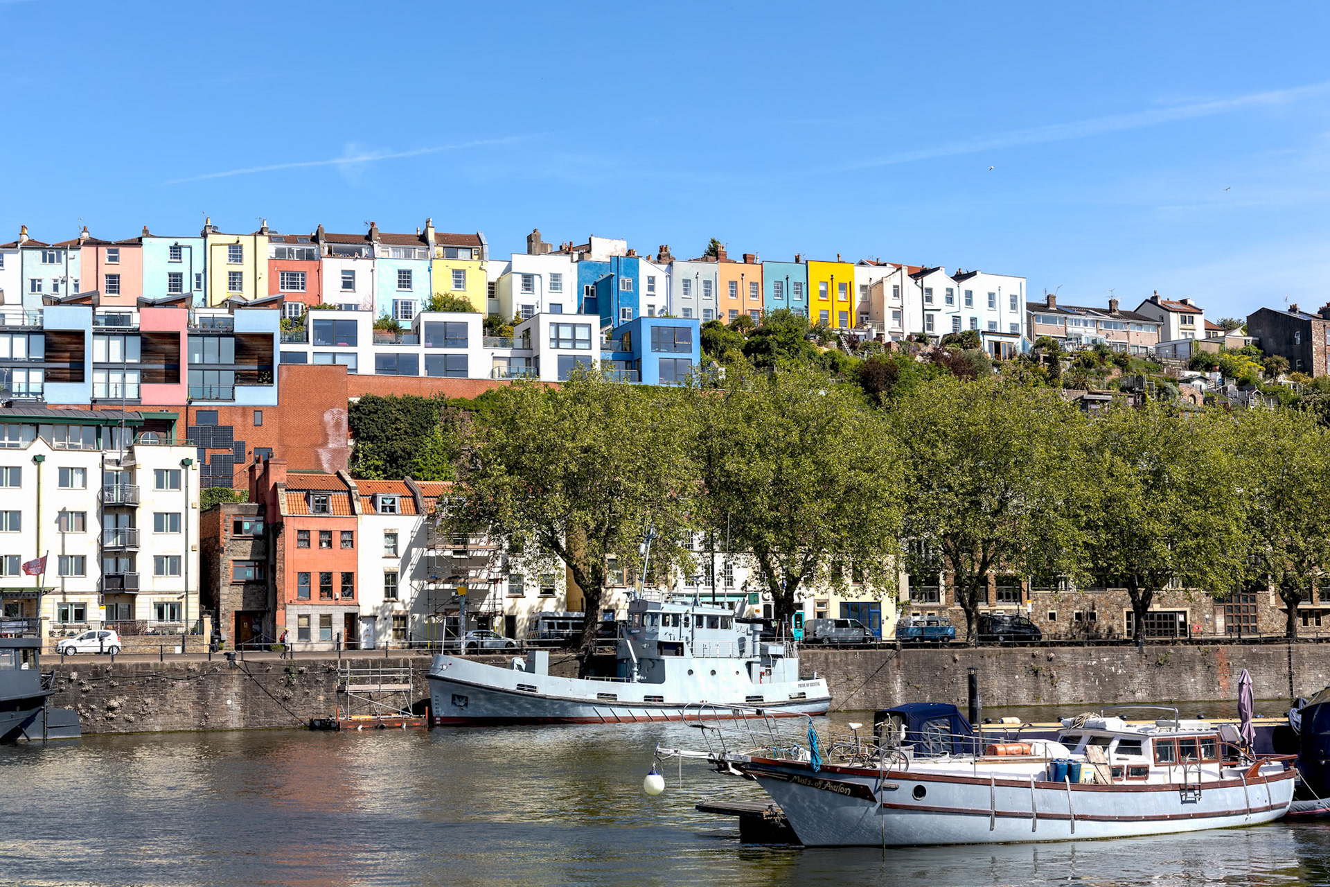 BRISTOL, UK - MAY 14 : View of boats and colourful apartments along the River Avon in Bristol on May 14, 2019. One unidentified person