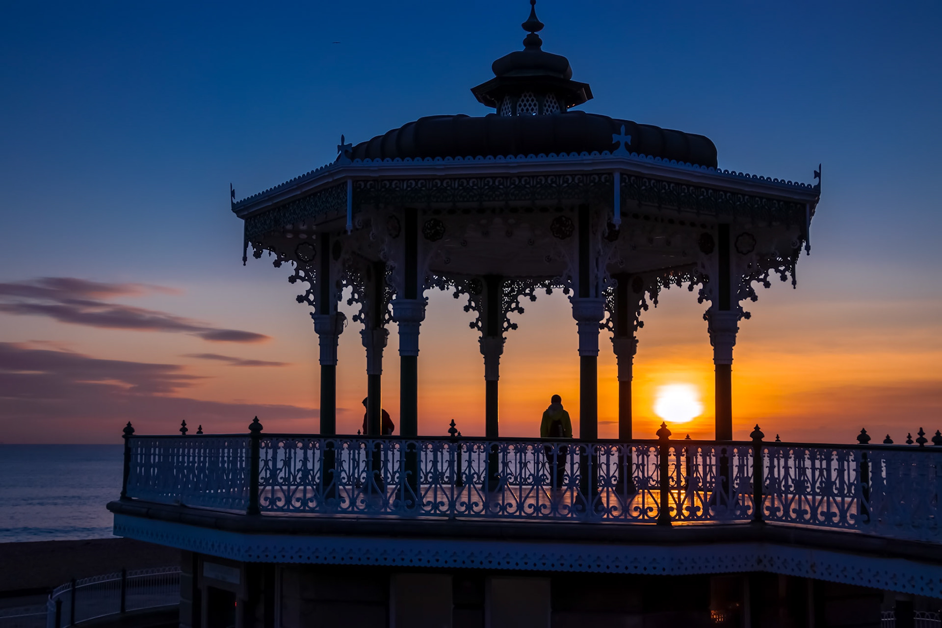 BRIGHTON, EAST SUSSEX/UK - JANUARY 26 : View of the sunset from a bandstand in Brighton East Sussex on January 26, 2018. Unidentified people.