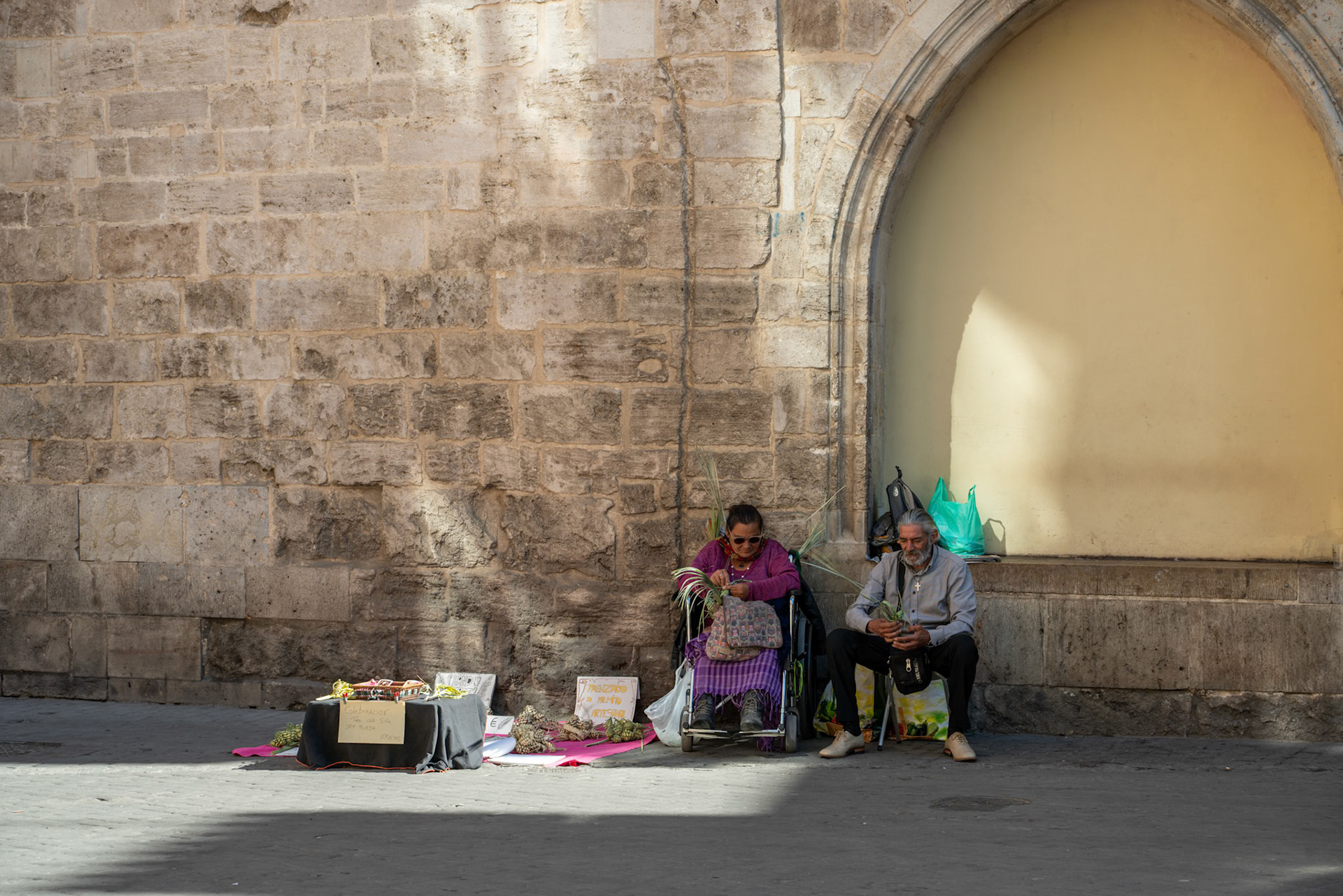 VALENCIA, SPAIN - FEBRUARY 25 : Two people selling craft items in the old town Valencia Spain on February 25, 2019. Two unidentified people