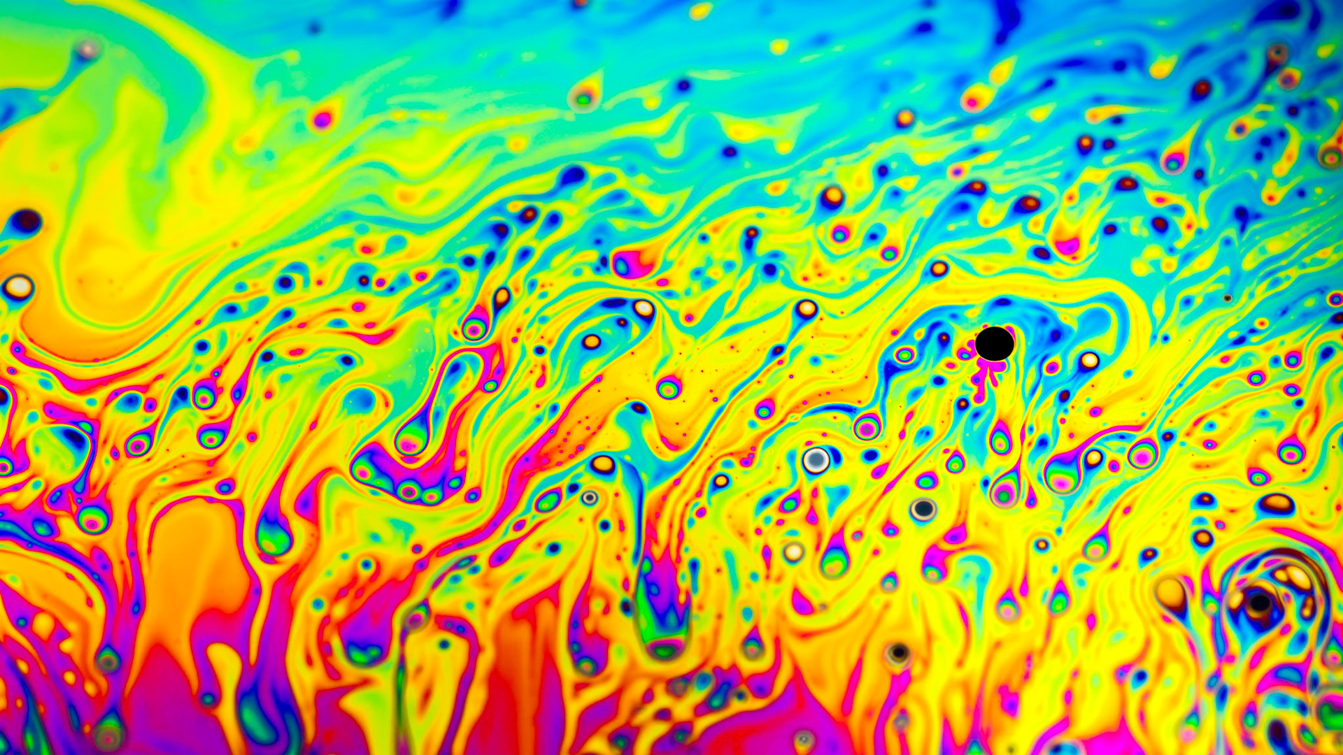Extreme close-up of the colourful surface of a bubble
