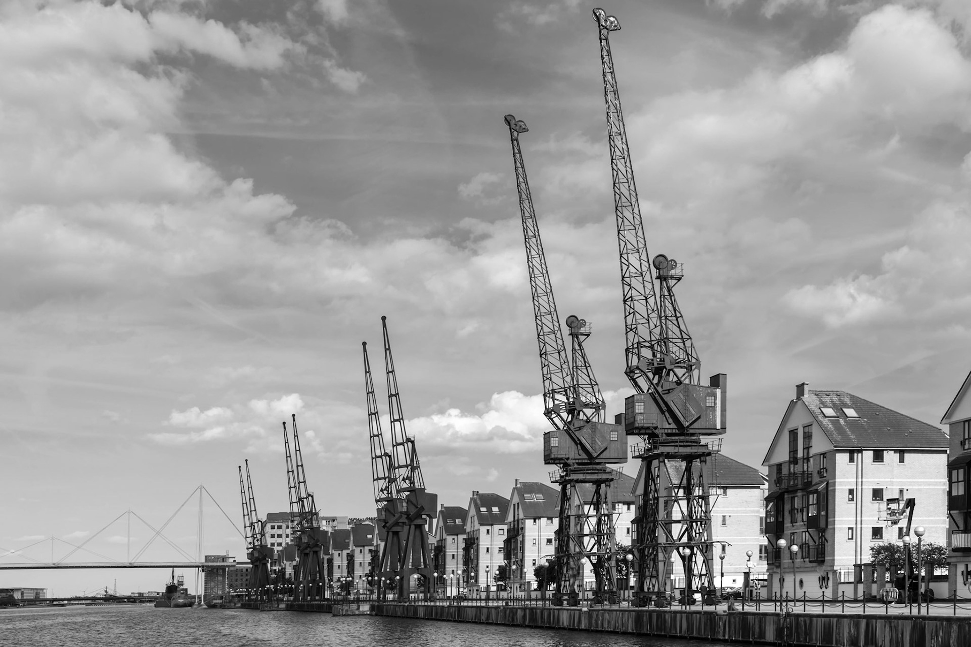 Old Dockside Cranes alongside a Waterfront Development  in London
