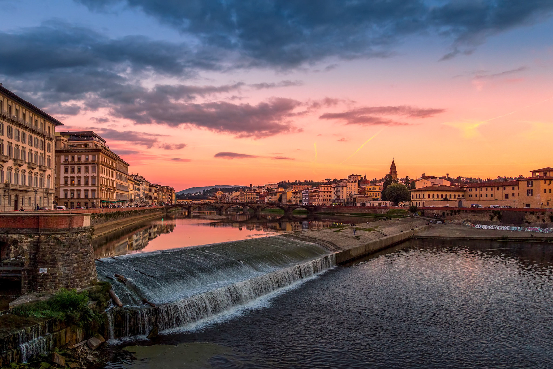 FLORENCE, TUSCANY/ITALY - OCTOBER 19 : View of buildings along the River Arno at dusk in Florence  on October 19, 2019. Unidentified people