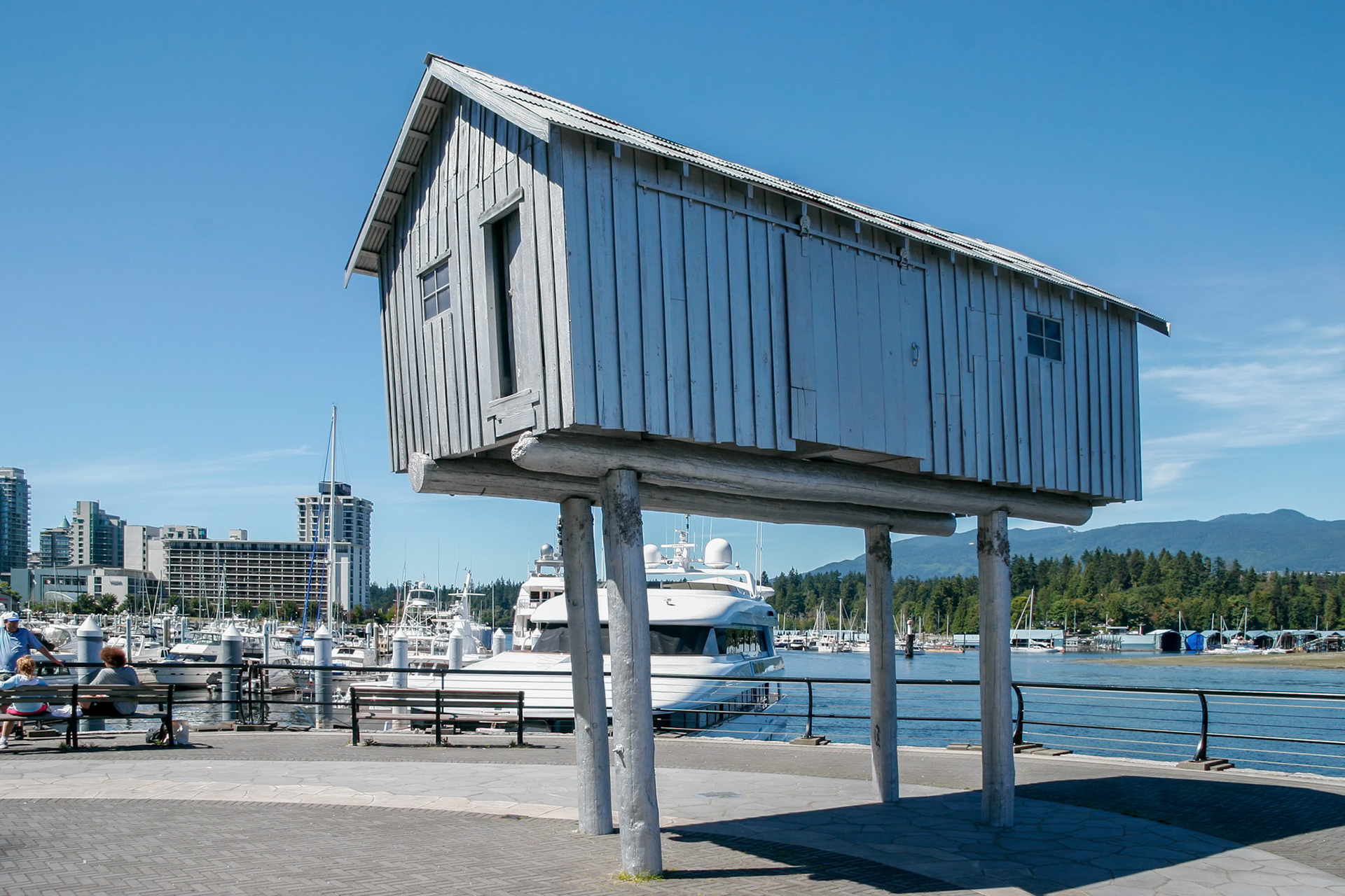 VANCOUVER, BC, CANADA - AUG 14, 2007 - Canadian sculptor Liz Magor's aluminum art piece "LightShed" located in Coal Harbour, Vancouver on August 14, 2007. Three unidentified people