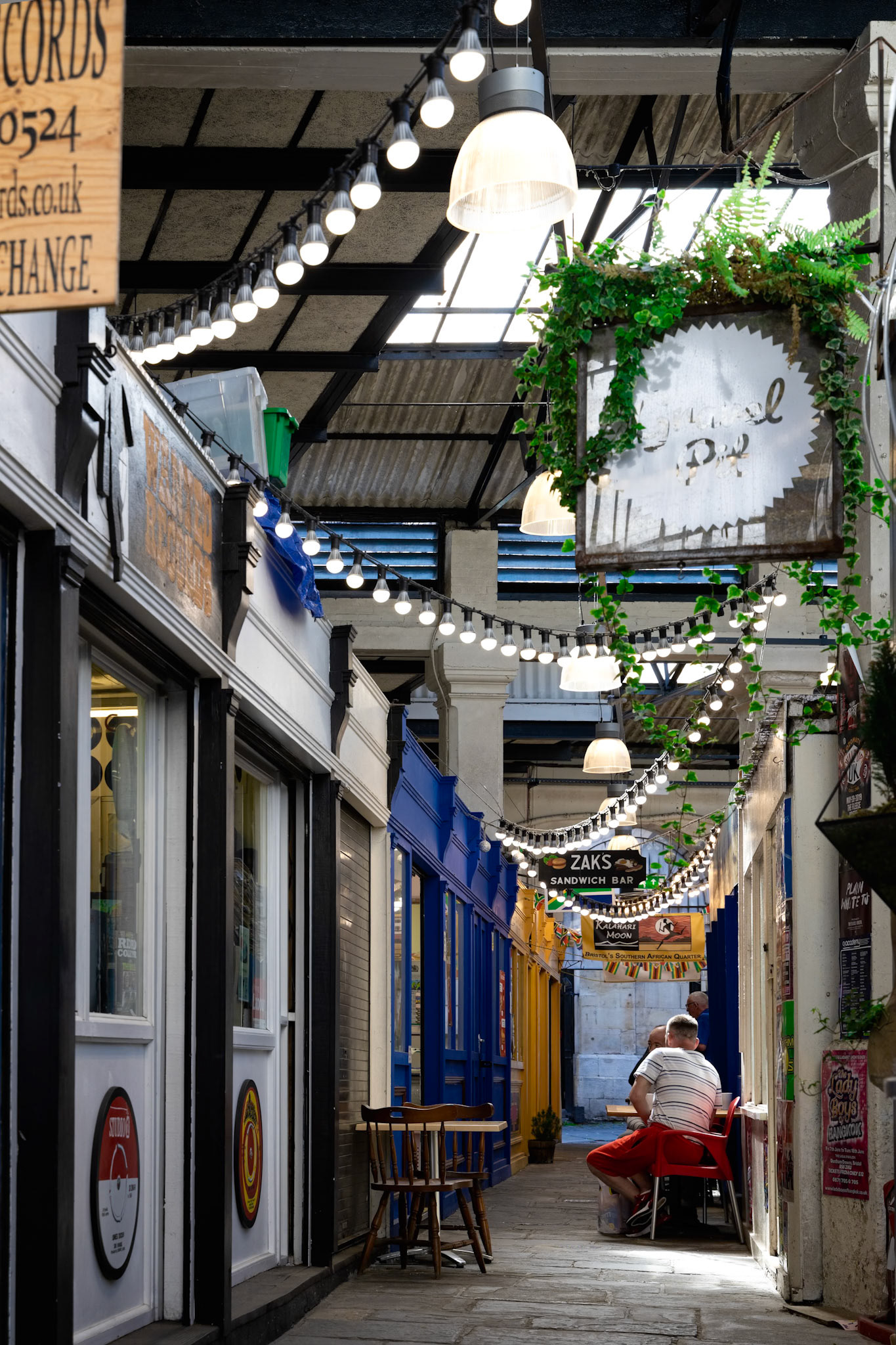 BRISTOL, UK - MAY 14 : View of St Nicholas Market buildings  in Bristol on May 14, 2019. Three unidentified people