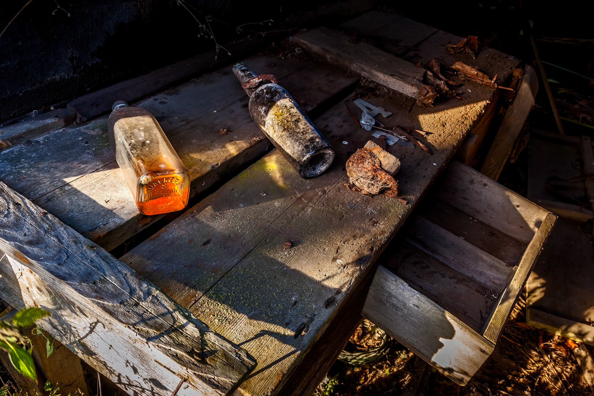 Bottles on a bench in a derelict building