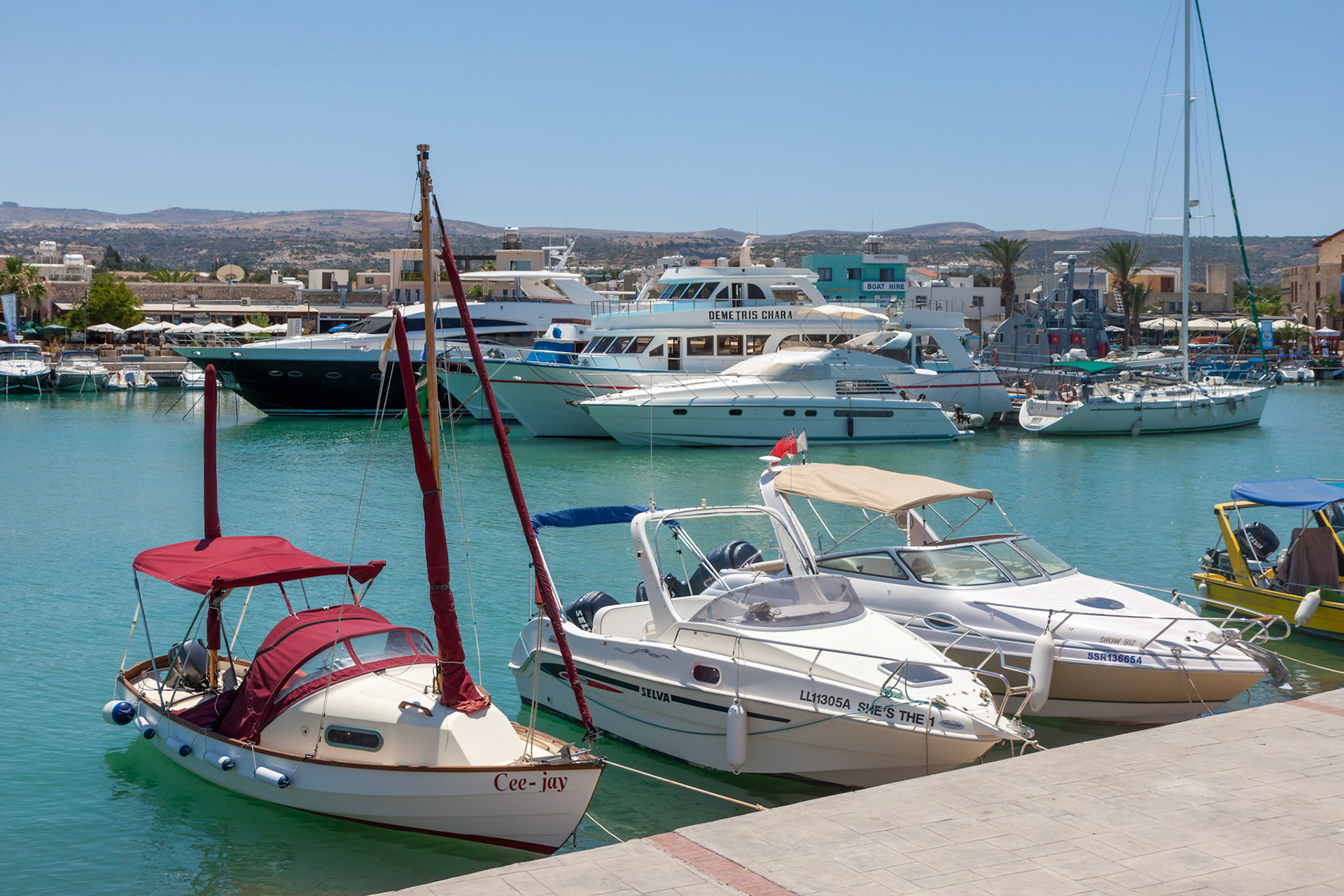 LATCHI, CYPRUS, GREECE - JULY 23 : Assortment of boats in the marina at Latchi Cyprus on July 23, 2009. Two unidentified people