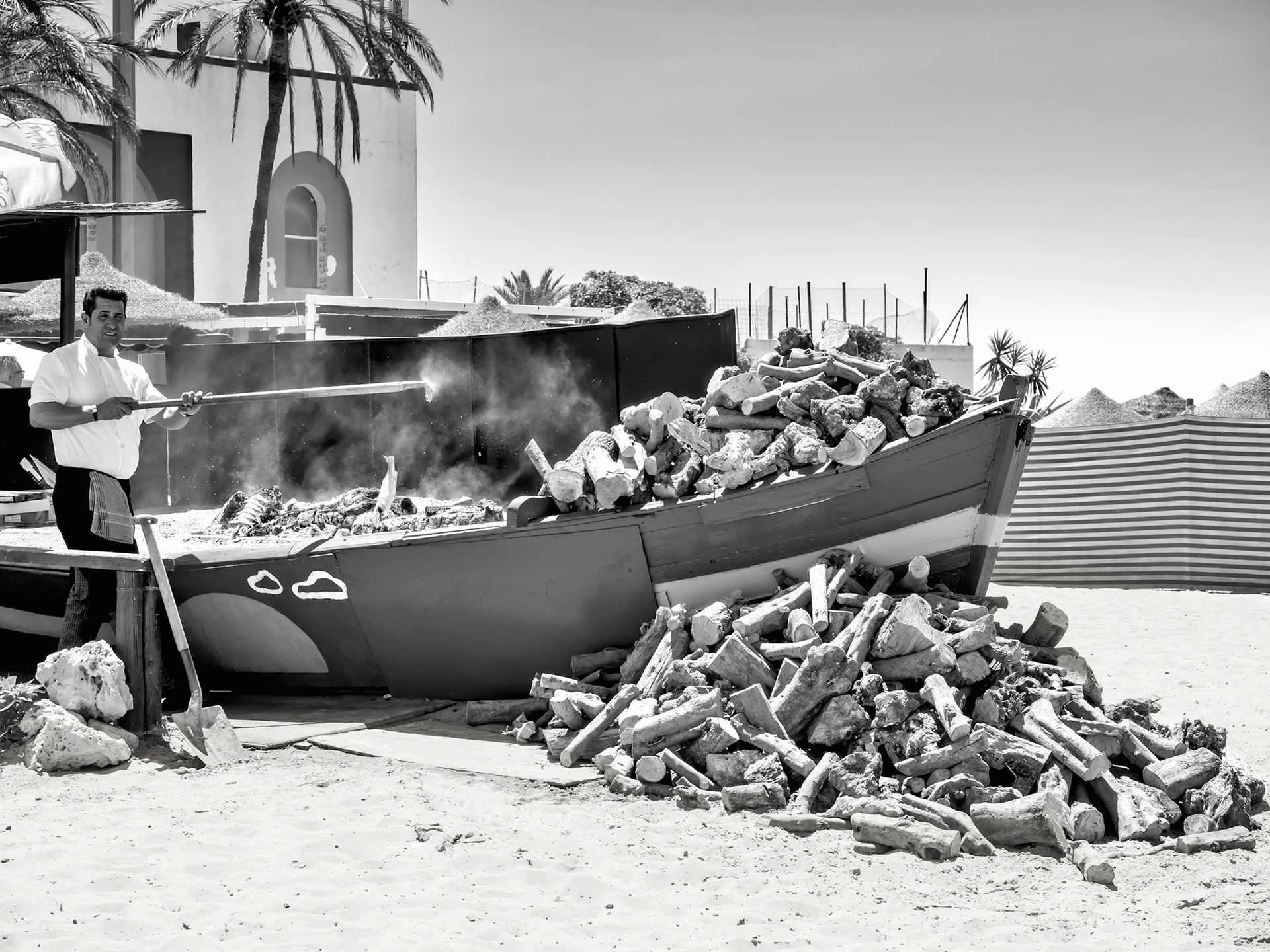 Man Cooking Fish on the Beach in Marbella