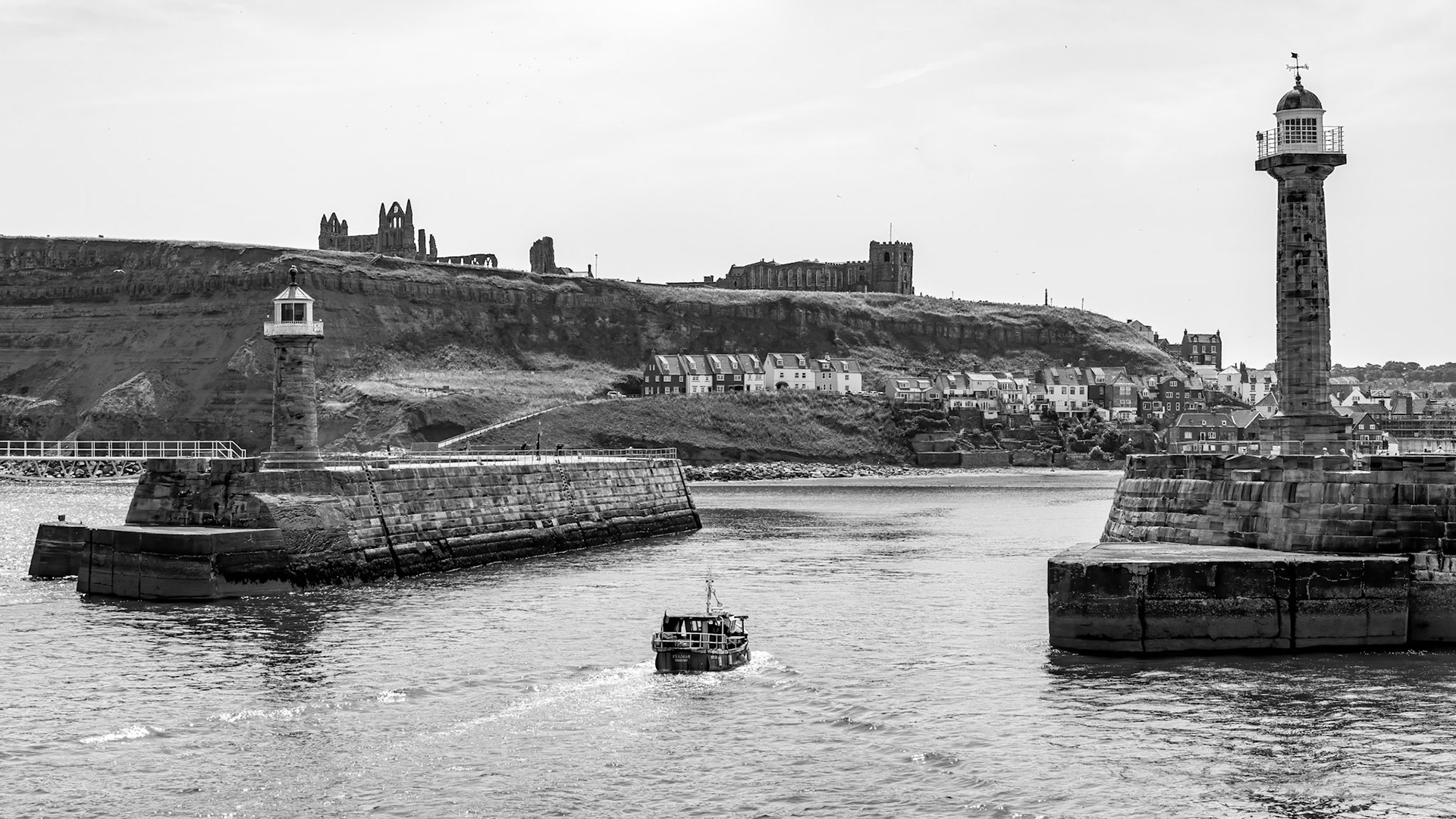 WHITBY,  NORTH YORKSHIRE, UK - JULY 19: View of the harbour entrance in Whitby, North Yorkshire on July 19, 2022