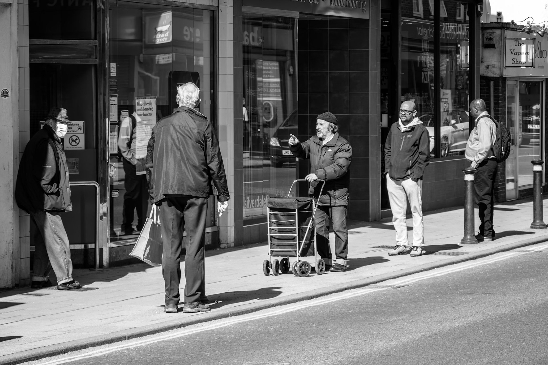 EAST GRINSTEAD, WEST SUSSEX, UK - APRIL 20 : Social distancing while queueing for the building society in East Grinstead due to Coronavirus on April 20, 2020. Unidentified people