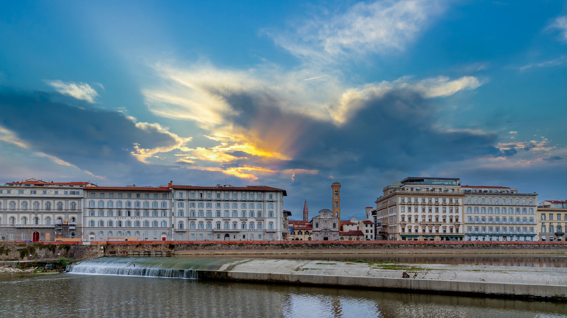 FLORENCE, TUSCANY/ITALY - OCTOBER 20 : Weir across the River Arno in Florence  on October 20, 2019. Unidentified people