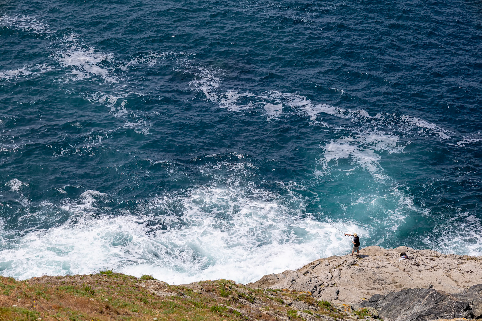 Trevose Head, Cornwall, UK - June 15.  Man fishing at Trevose Head in Cornwall on June 15, 2023. Unidentified man