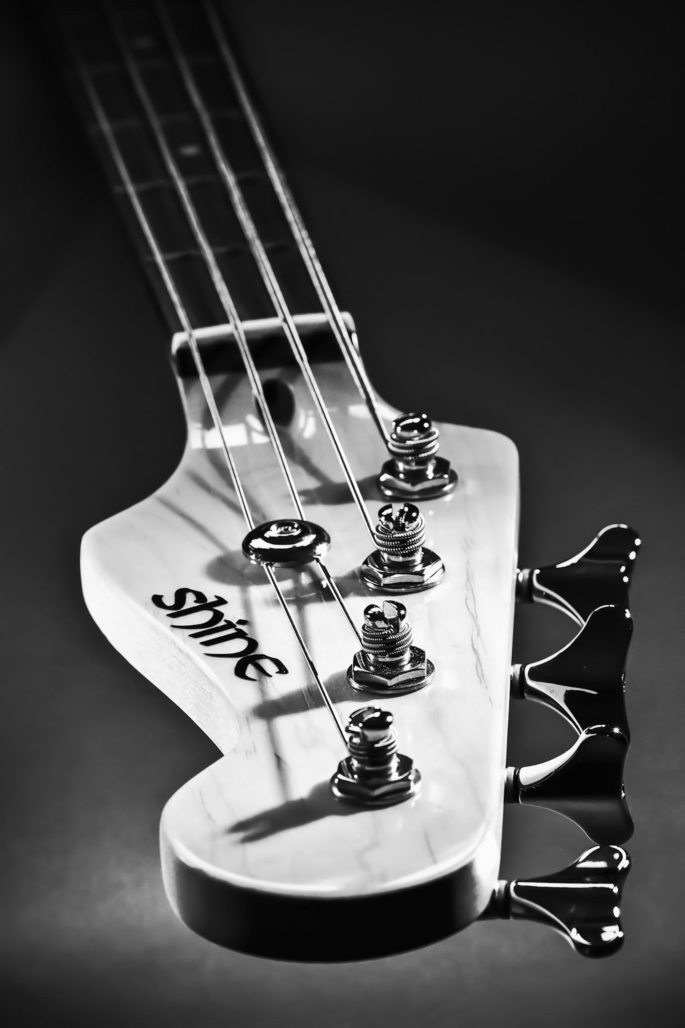Close-up Electric Bass Guitar Head and Tuning Pegs