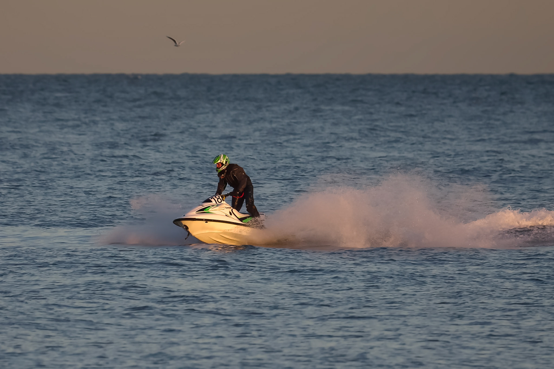 DUNGENESS, KENT/UK - DECEMBER 17 : Man riding a jet ski off Dungeness beach in Kent on December 17, 2008. One unidentified person