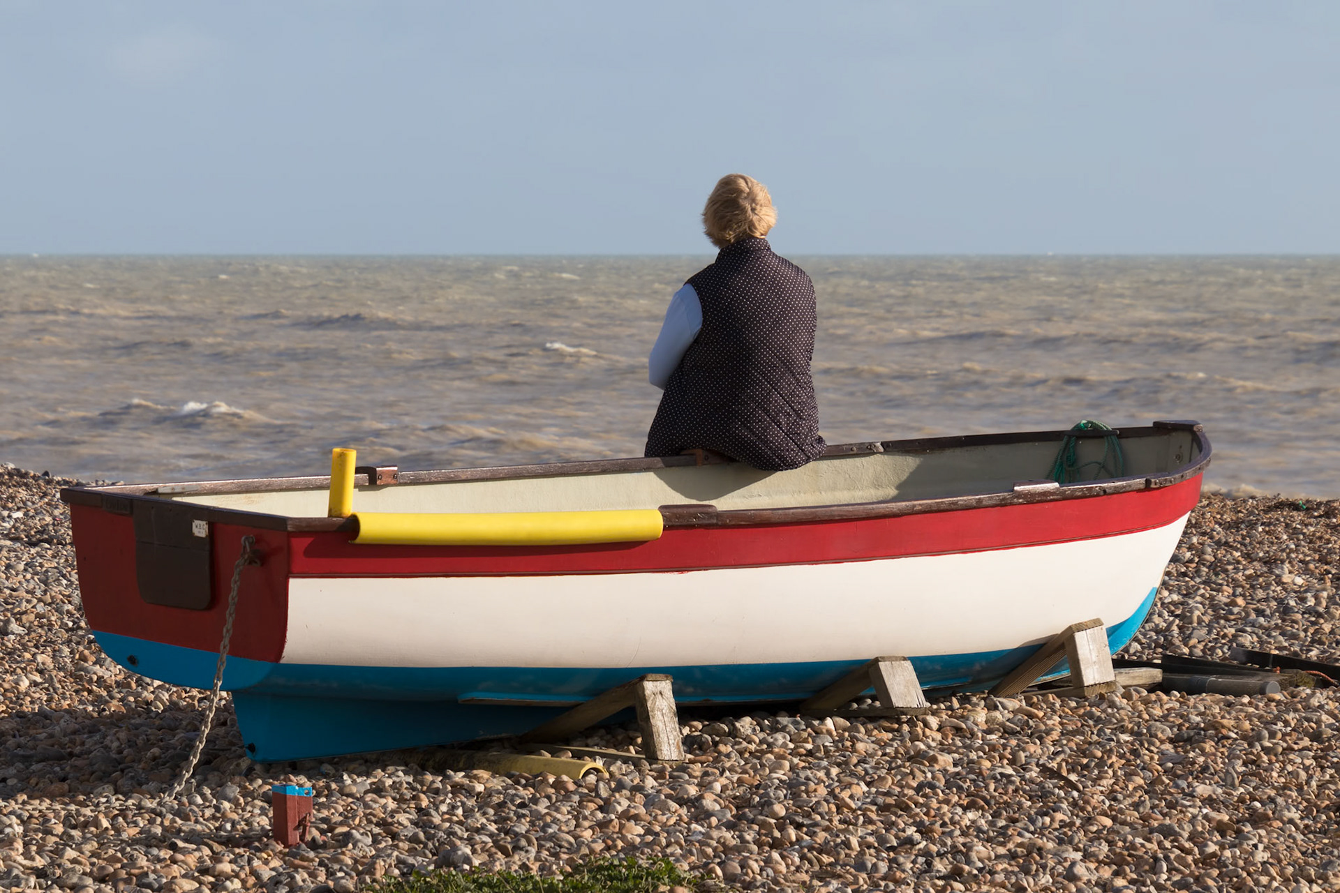 WORTHING, WEST SUSSEX/UK - NOVEMBER 13 : Lady sitting on a rowing boat in Worthing West Sussex on November 13, 2018. One unidentified woman