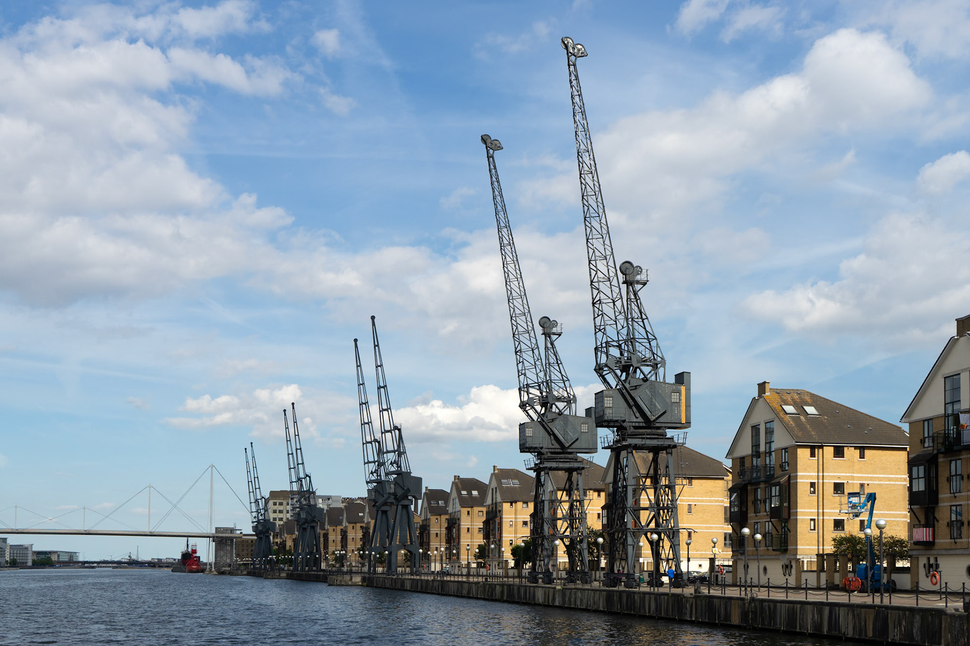 Old Dockside Cranes alongside a Waterfront Development  in London