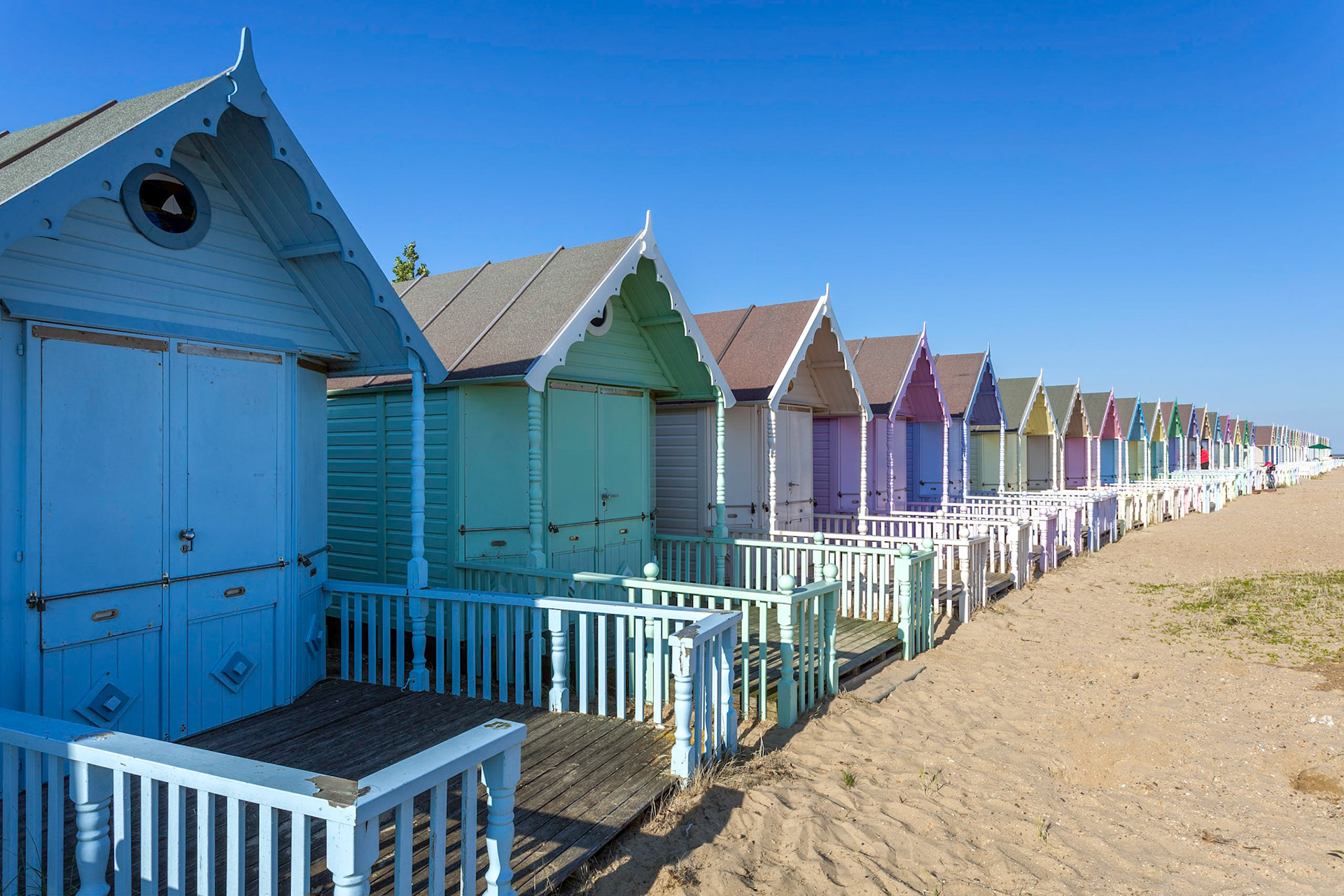 WEST MERSEA, ESSEX/UK - JULY 24 : Colourful beach huts in West Mersea Essex on July 24, 2012