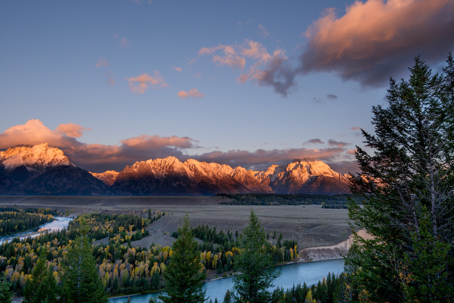 First rays of the sun illuminating the Grand Teton mountain range in Wyoming