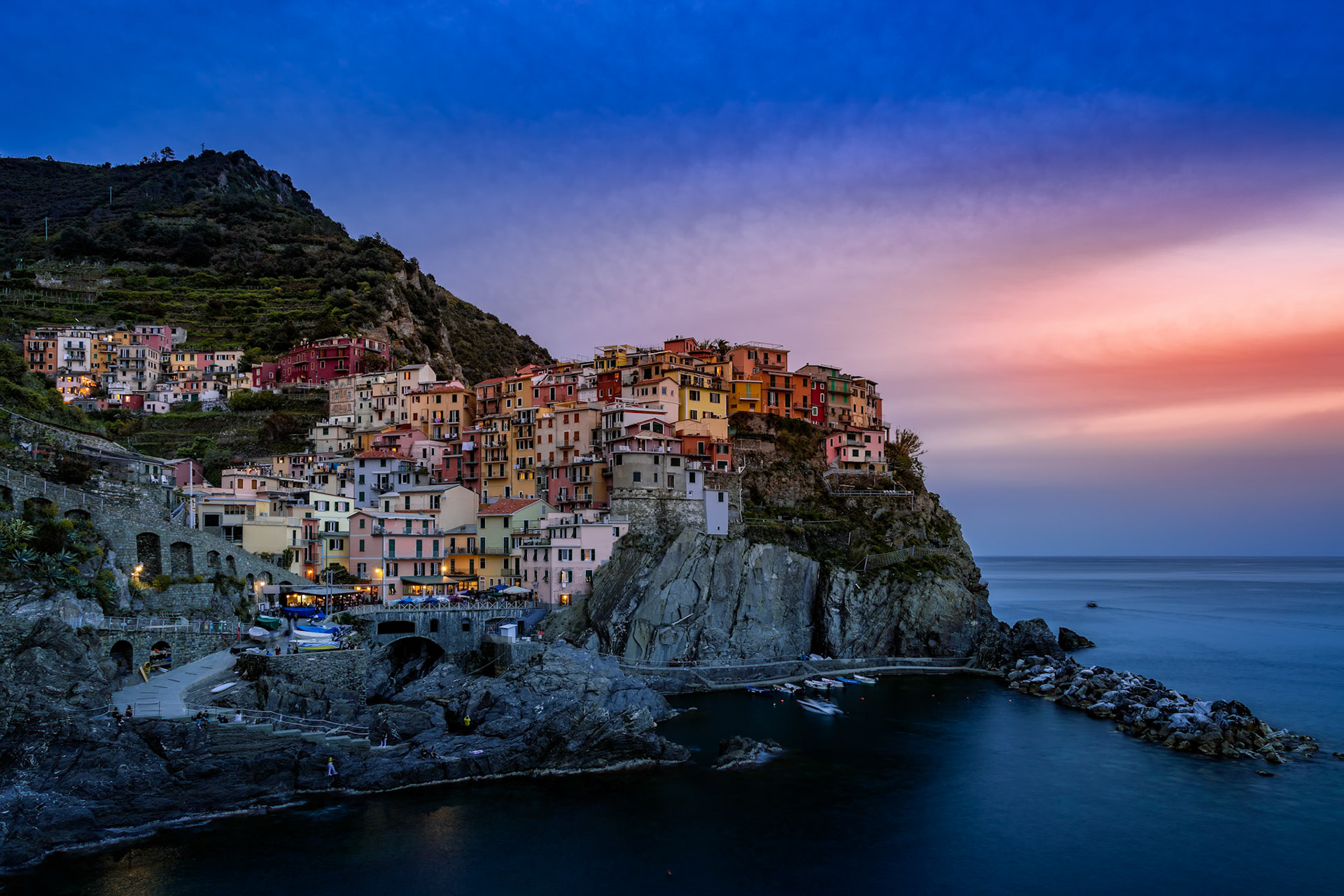 MANAROLA, LIGURIA/ITALY  - APRIL 20 : Coastal view at dusk of Manarola Liguria Italy on April 20, 2019. Unidentified people