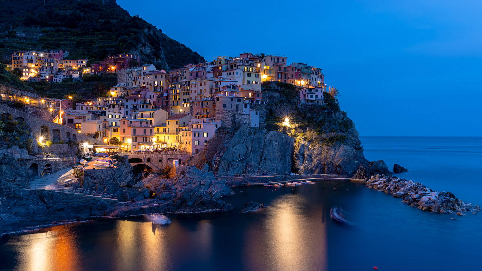 MANAROLA, LIGURIA/ITALY  - APRIL 20 : Coastal view at dusk of Manarola Liguria Italy on April 20, 2019. Unidentified people