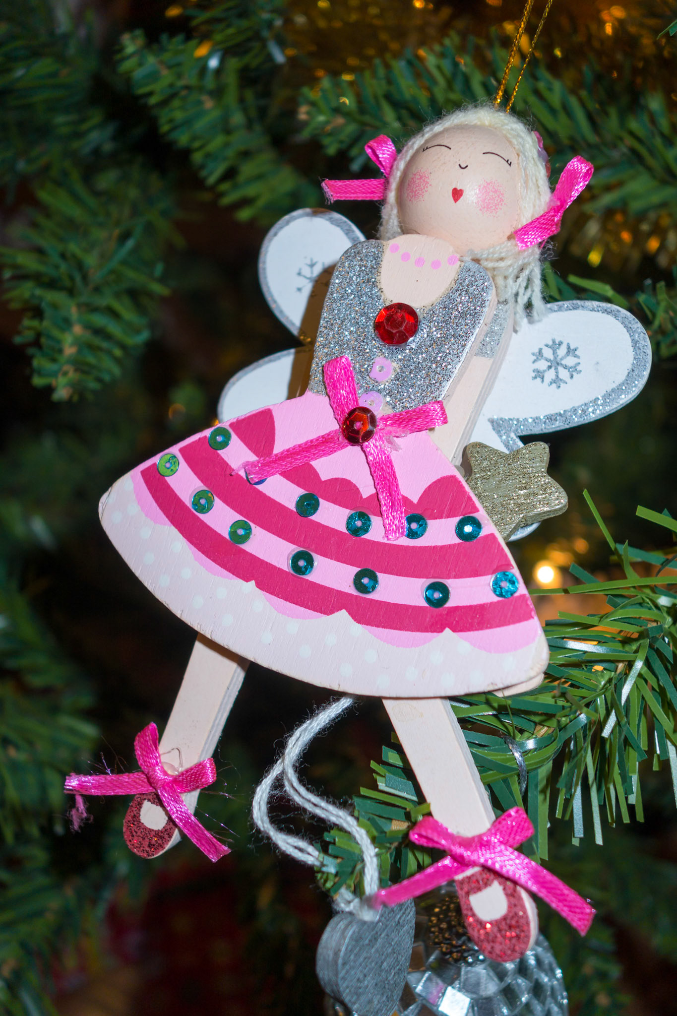 Funky angel decoration hanging on a christmas tree