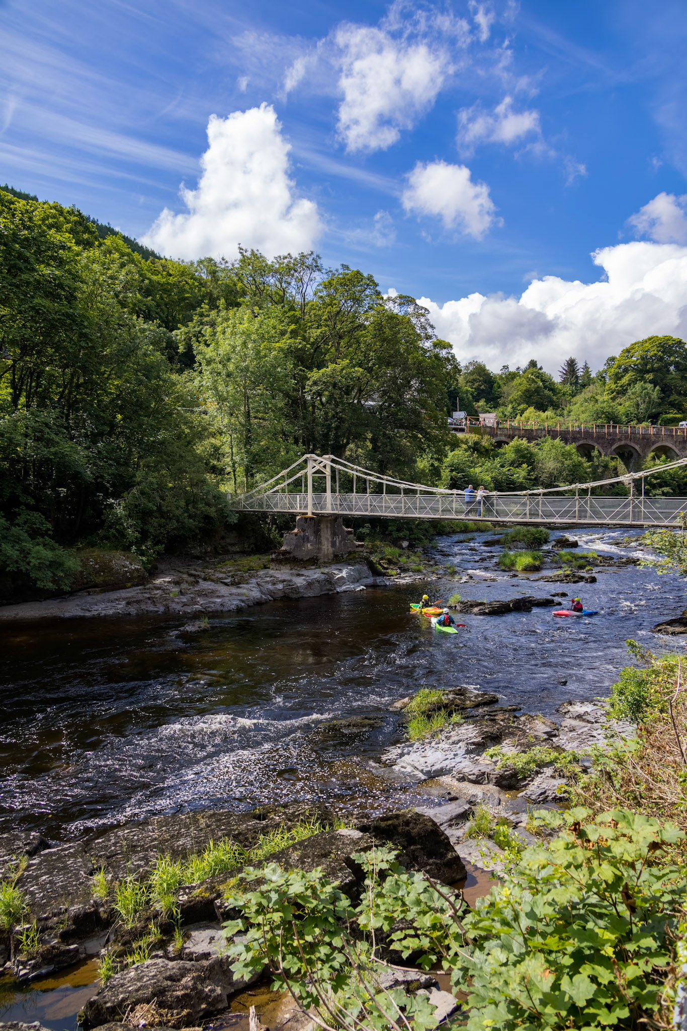BERWYN, DENBIGHSHIRE, WALES - JULY 11 : People kayaking by the Chainbridge in Berwyn, Wales on July 11, 2021. Unidentified people