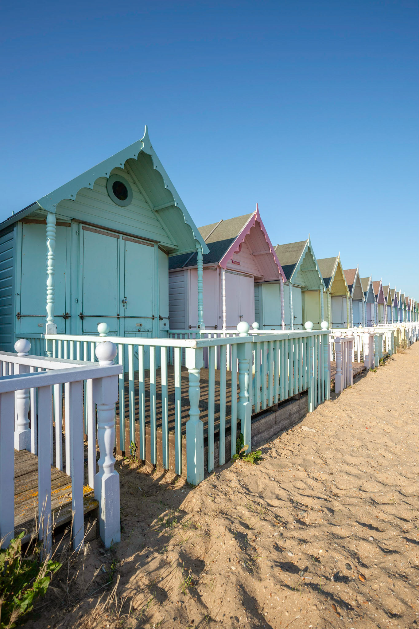 WEST MERSEA, ESSEX/UK - JULY 24 : Colourful beach huts in West Mersea Essex on July 24, 2012