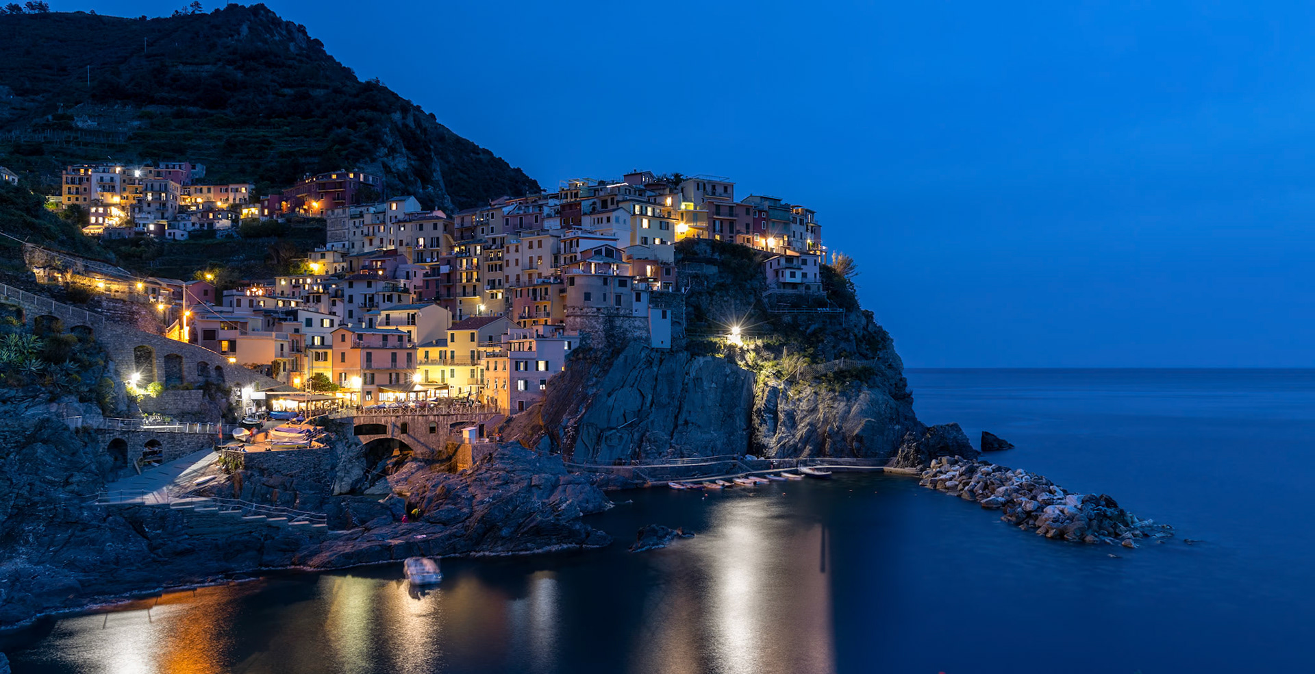 MANAROLA, LIGURIA/ITALY  - APRIL 20 : Night-time view of Manarola Liguria Italy on April 20, 2019. Unidentified people