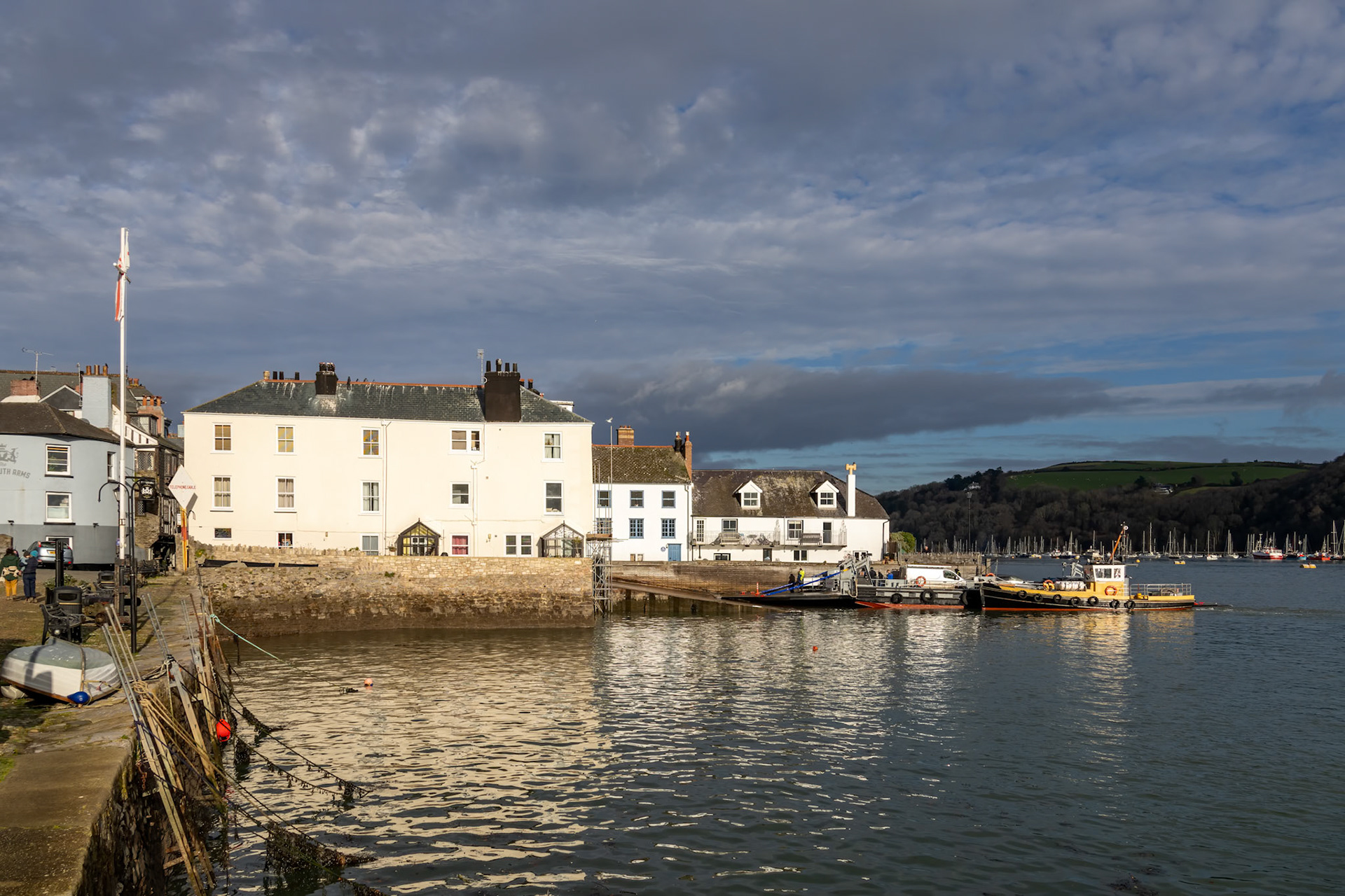 Dartmouth, Devon, UK - January 14. Late afternoon winter sun shining on buildings in Dartmouth, Devon on January 14, 2024. Unidentified people