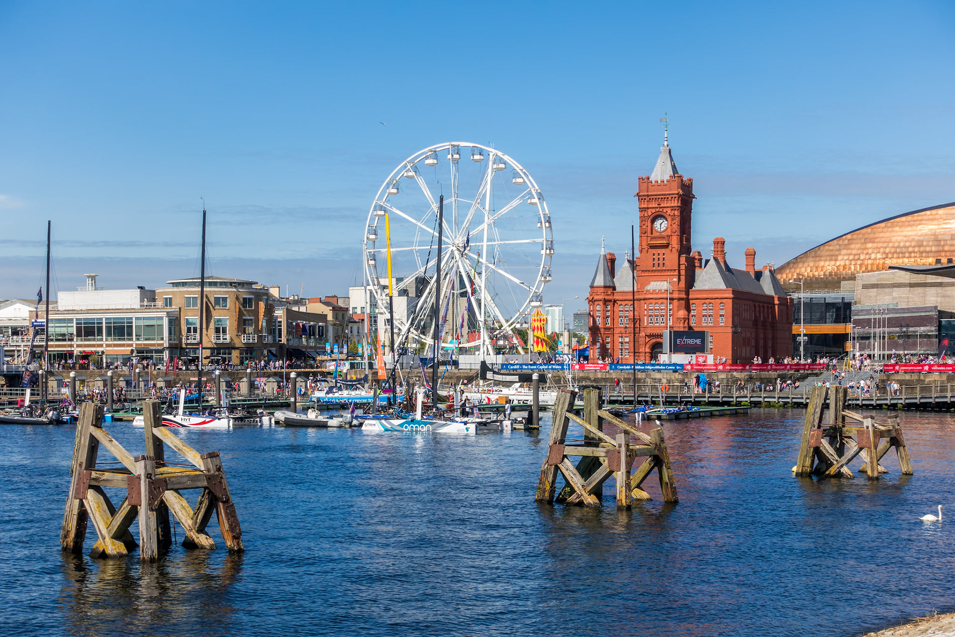 CARDIFF/UK - AUGUST 27 : Ferris Wheel and Pierhead Building in Cardiff on August 27, 2017. Unidentified people