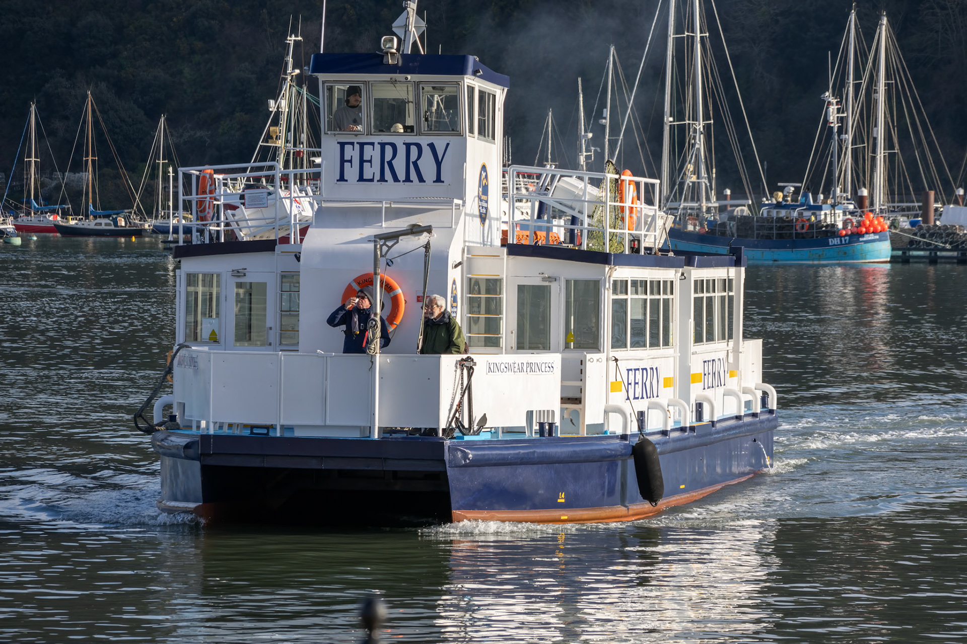 Dartmouth, Devon, UK - January 14. Passenger ferry crossing the River Dart in Dartmouth, Devon on January 14, 2024. Three unidentified people