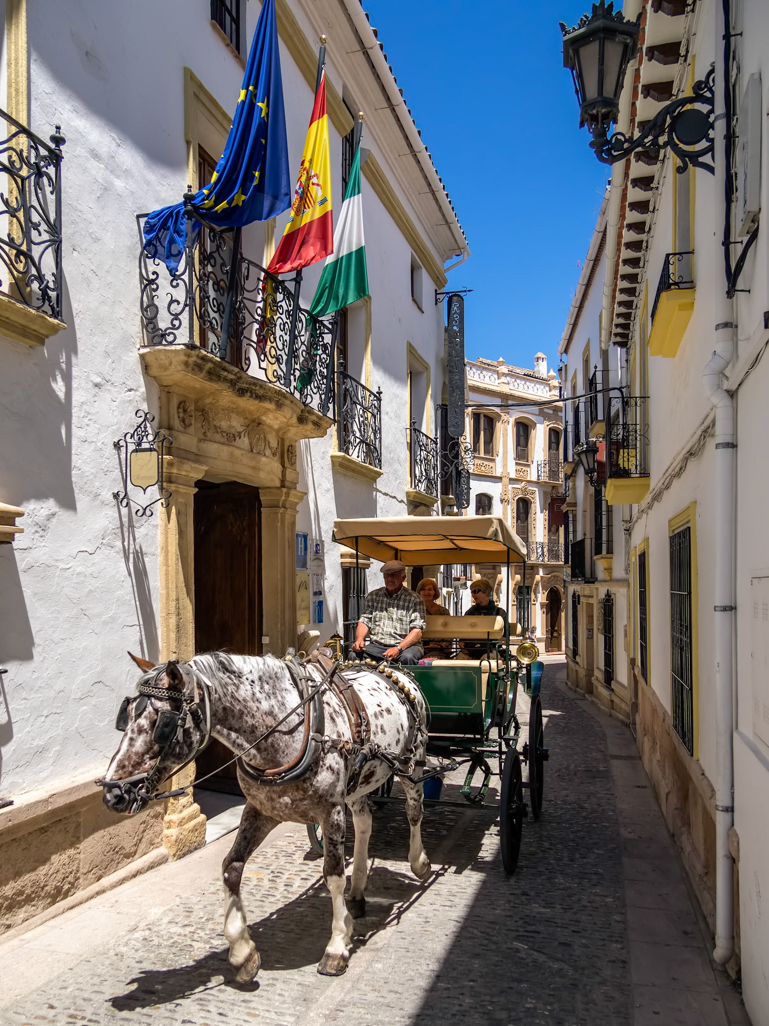 RONDA, ANDALUCIA/SPAIN - MAY 8 : Tourists enjoying a ride in a horse drawn carriage in Ronda Spain on May 8, 2014. Unidentified people.