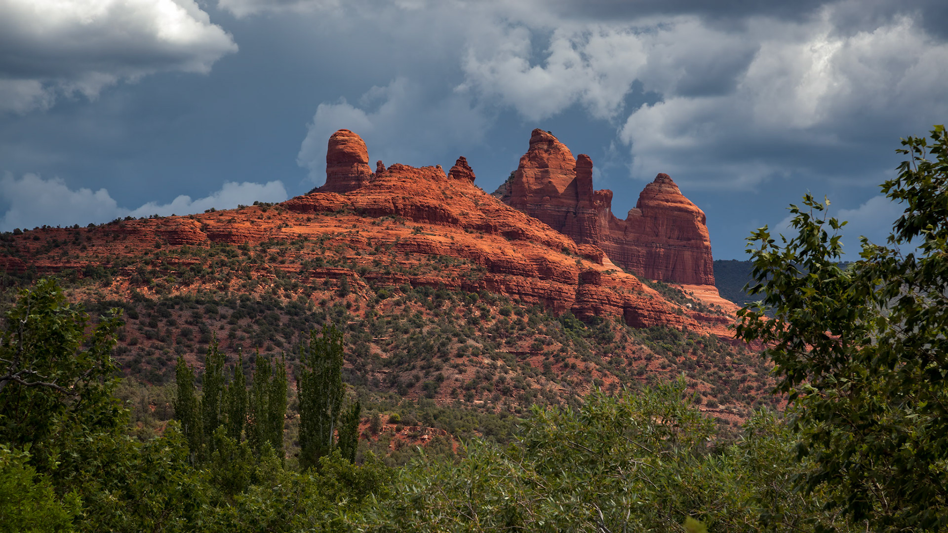 Stormy weather and bright sunshine over mountains surrounding Sedona