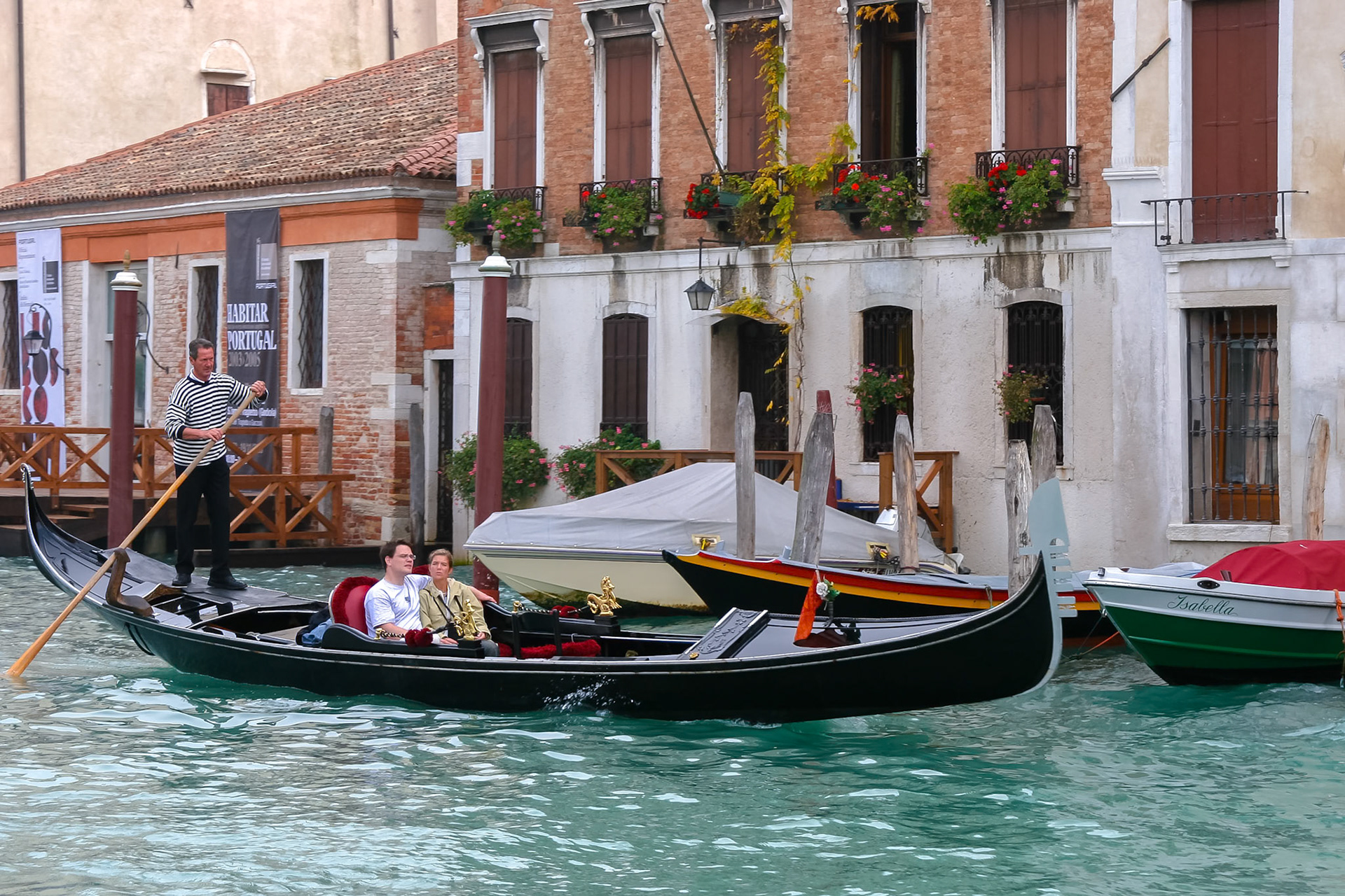 Gondolier Ferrying Passengers along a Canal in Venice