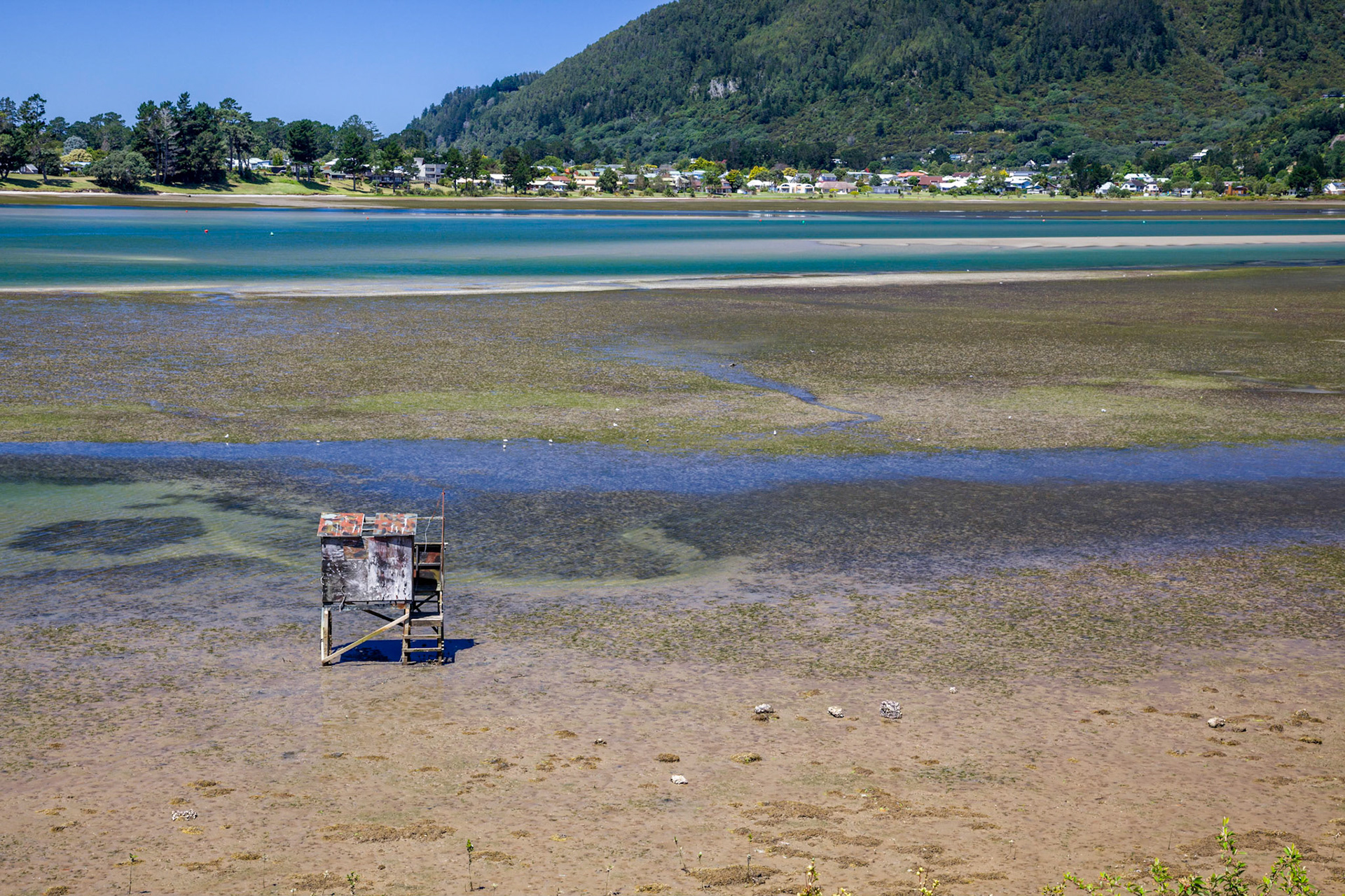 Old wooden fishing hut on stilts at Kairua inlet