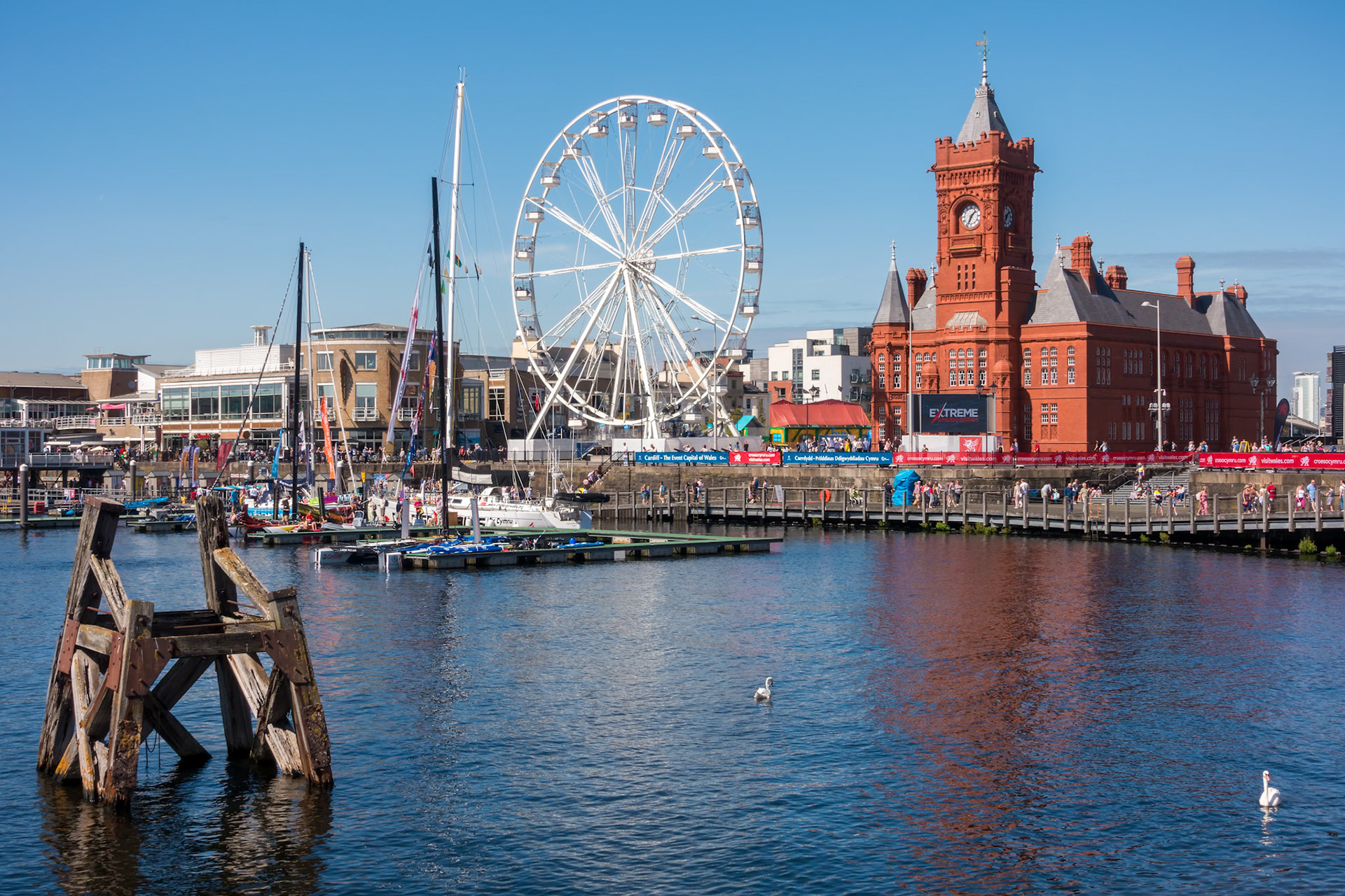 CARDIFF/UK - AUGUST 27 : Ferris Wheel and Pierhead Building in Cardiff on August 27, 2017. Unidentified people