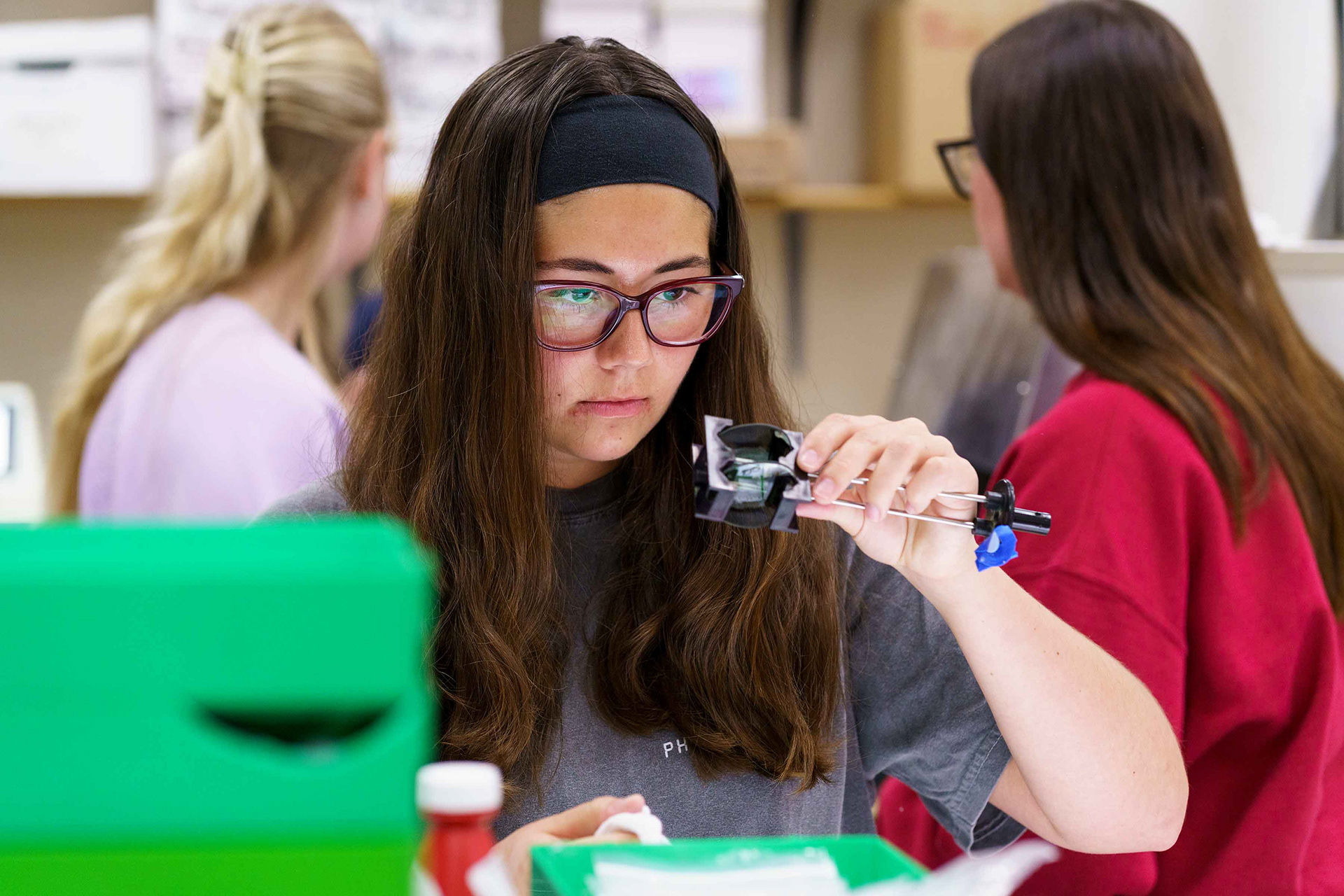 Optometry student in the lab making sunglasses.