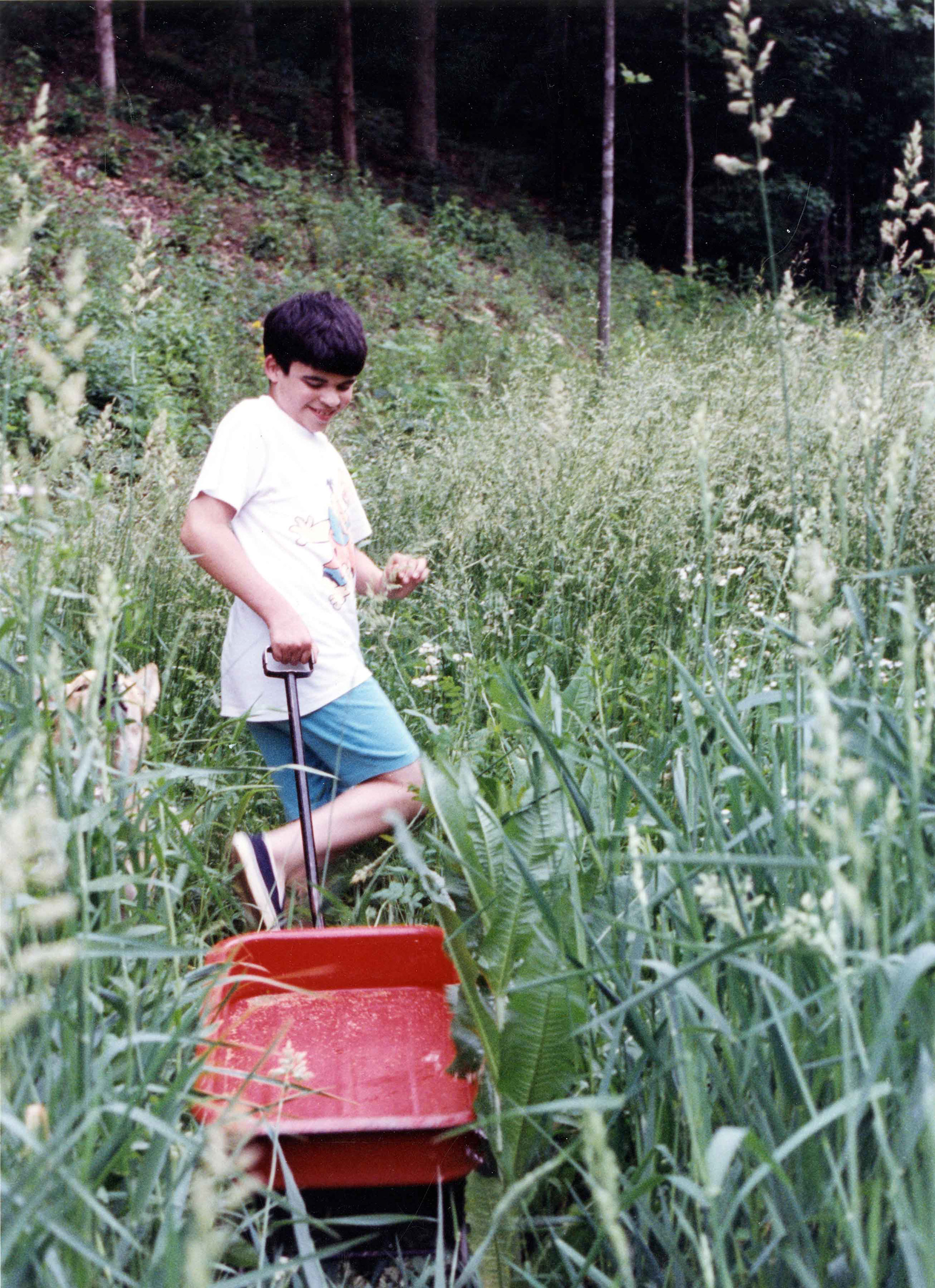 Boy with his red wagon.