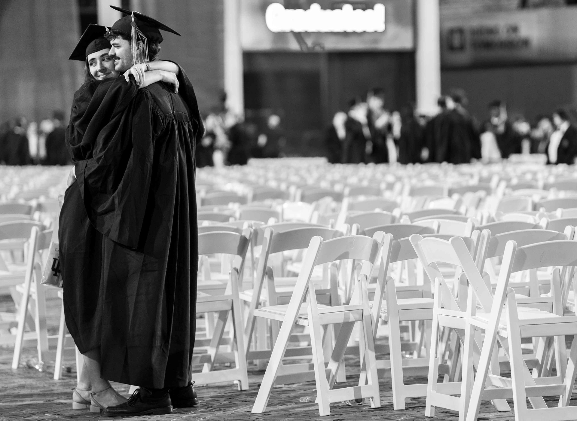 Grads hold each other tight after the ceremony.