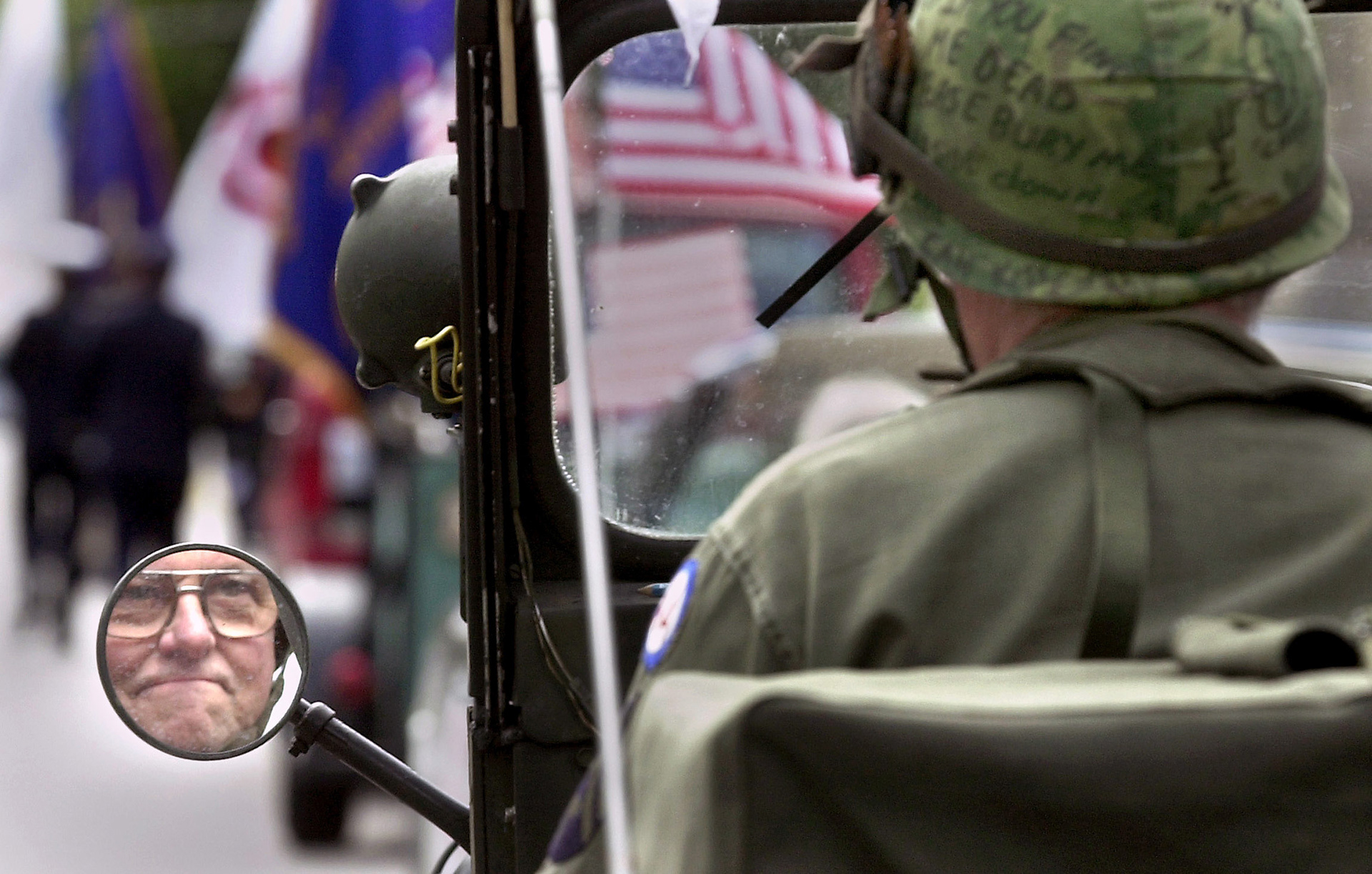 Korean War veteran William Leonard is reflected in the rearview mirror of his Jeep.