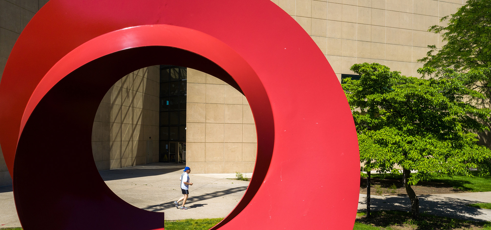 A man jogs past the Indiana Arc on the IU Bloomington campus.