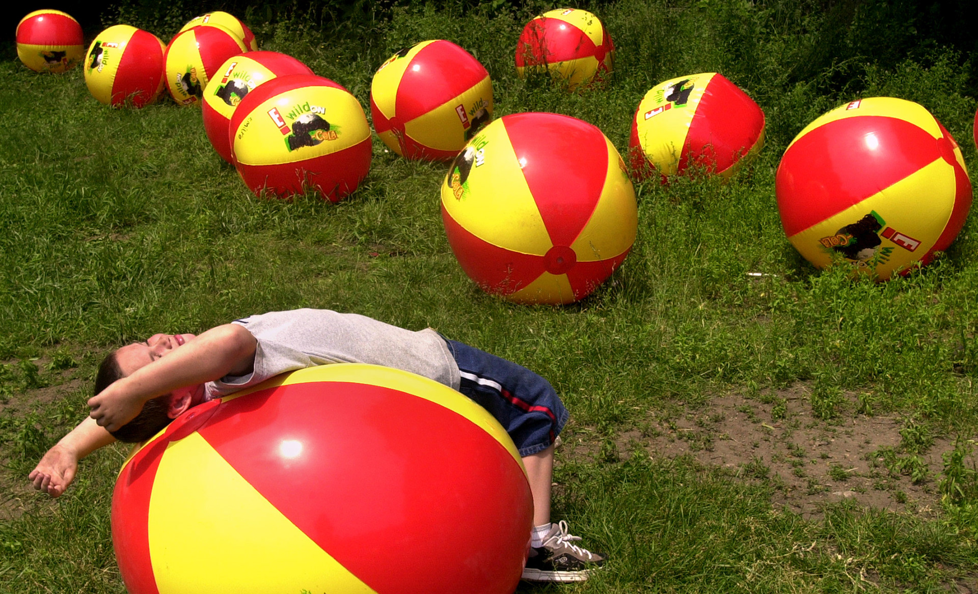 Cody McGraw lounges on a beach ball while taking a break from field day activities.