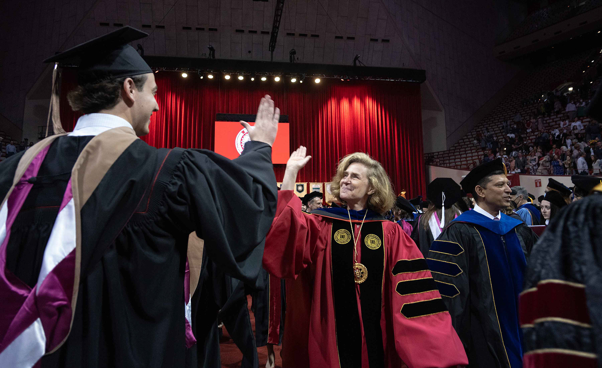 IU President Whitten congratulates grad students.